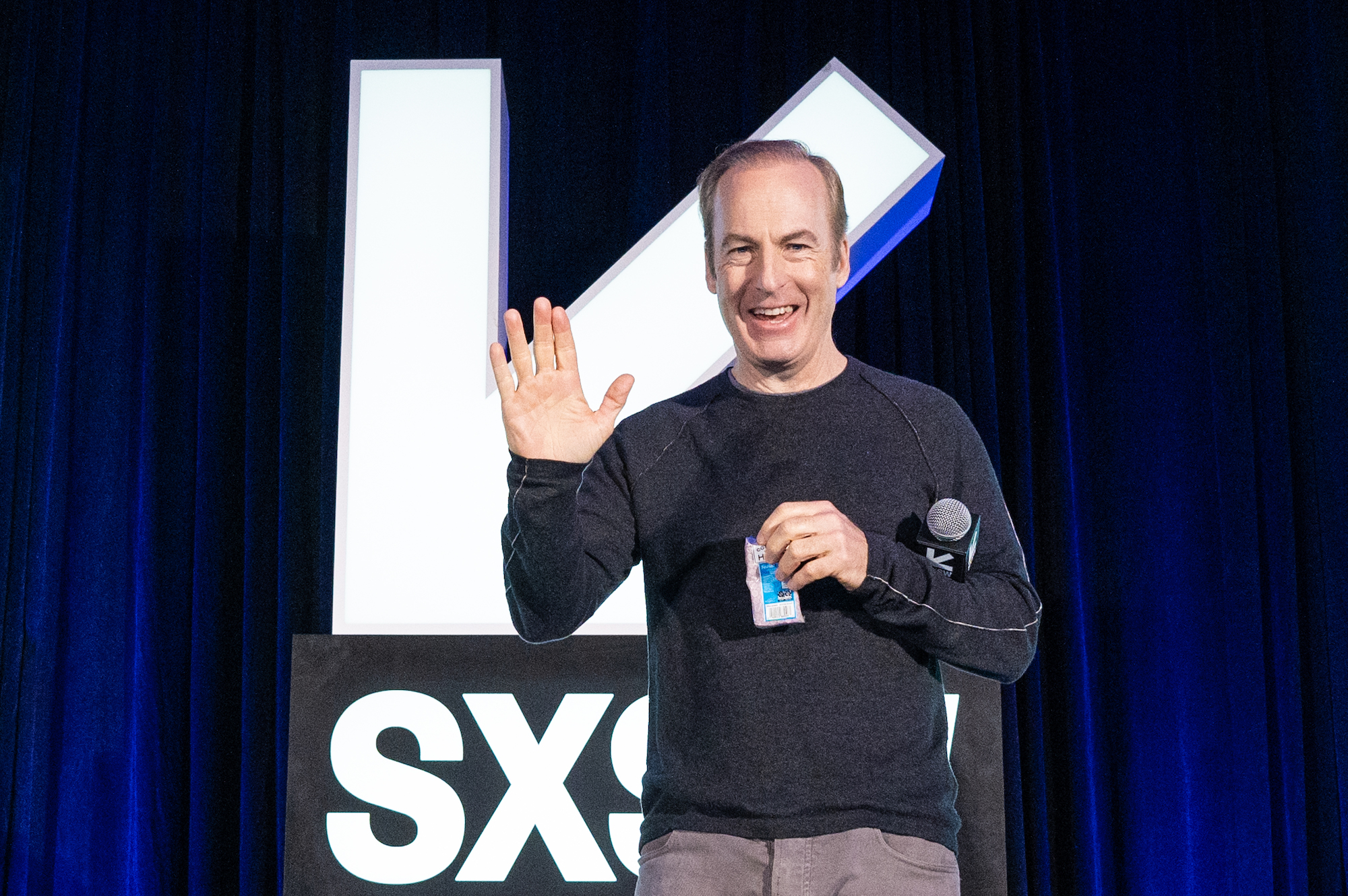 Bob Odenkirk waves on stage at SXSW