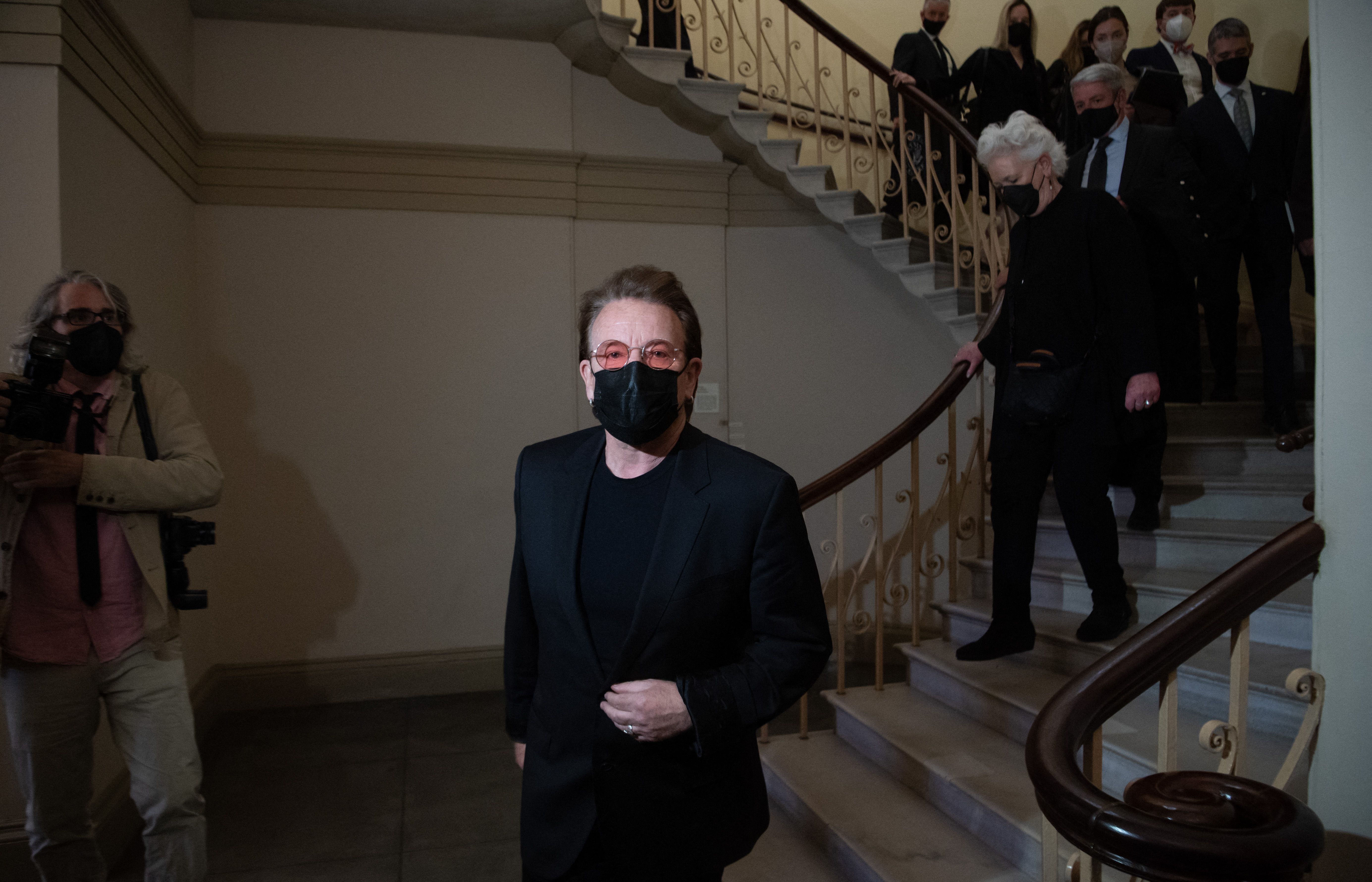 Musician Bono, lead singer of U2, walks between meetings with US lawmakers
