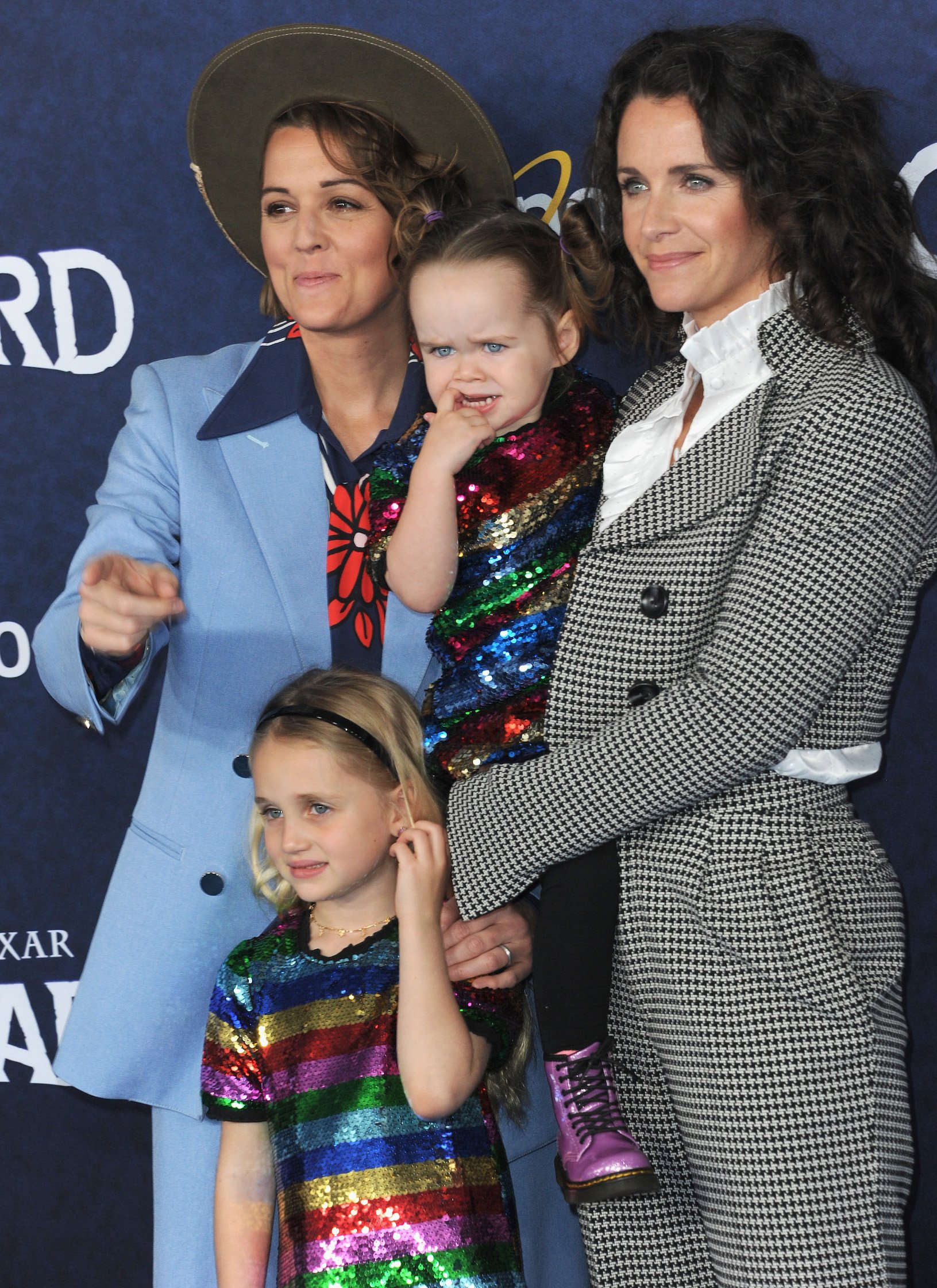 Brandi Carlile, Catherine Shepherd, and their children arriving at a Disney premiere