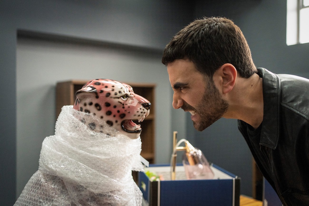 Brett Goldstein as Roy Kent growling at a tiger statue in season 2 of 'Ted Lasso'