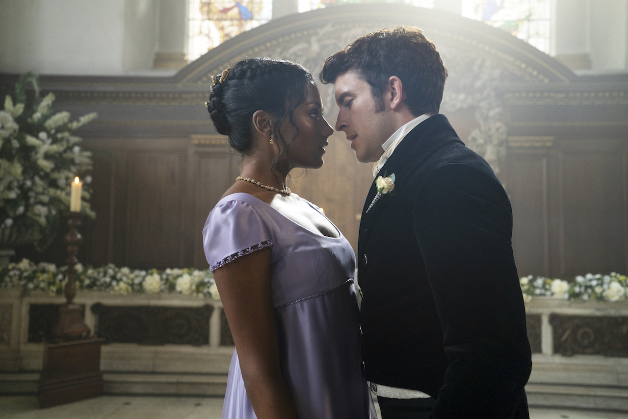 In a scene from 'Bridgerton' Season 2, Simone Ashley and Jonathan Bailey face each other in a church.