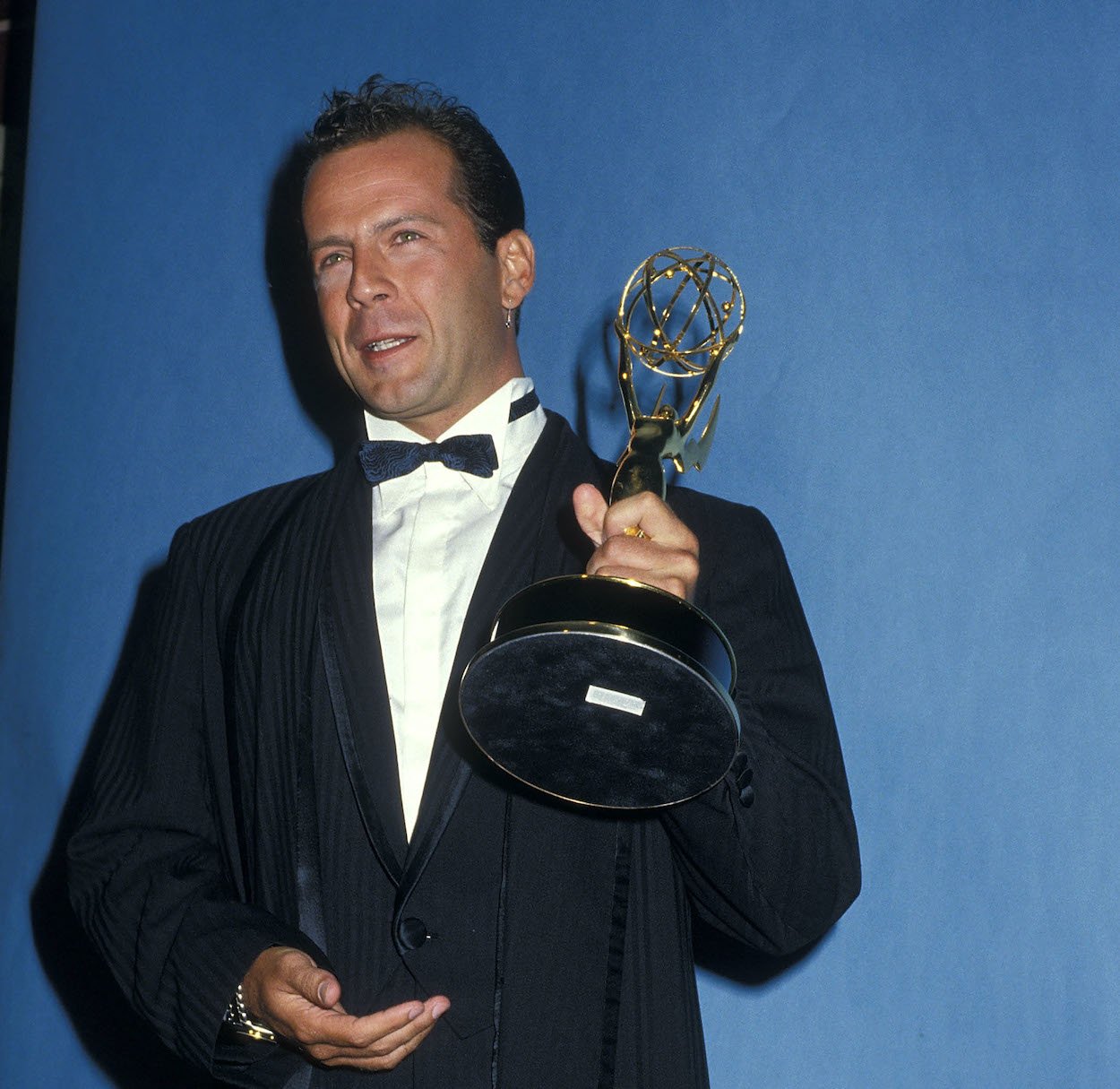 Bruce Willis poses with his 1987 Primetime Emmy Award for outstanding lead actor in a drama series.