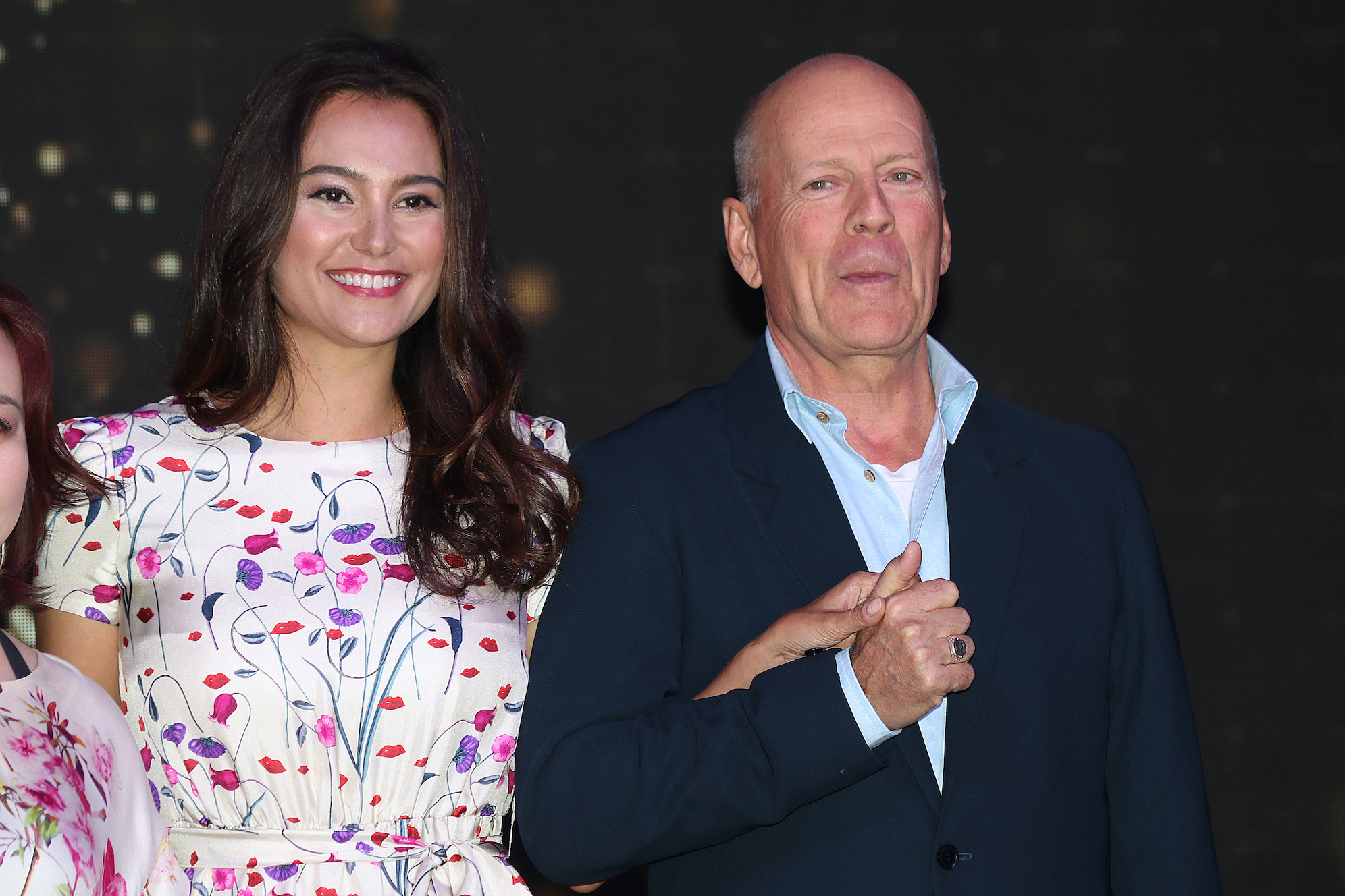 Bruce Willis and Emma Heming Willis together at an event and smiling