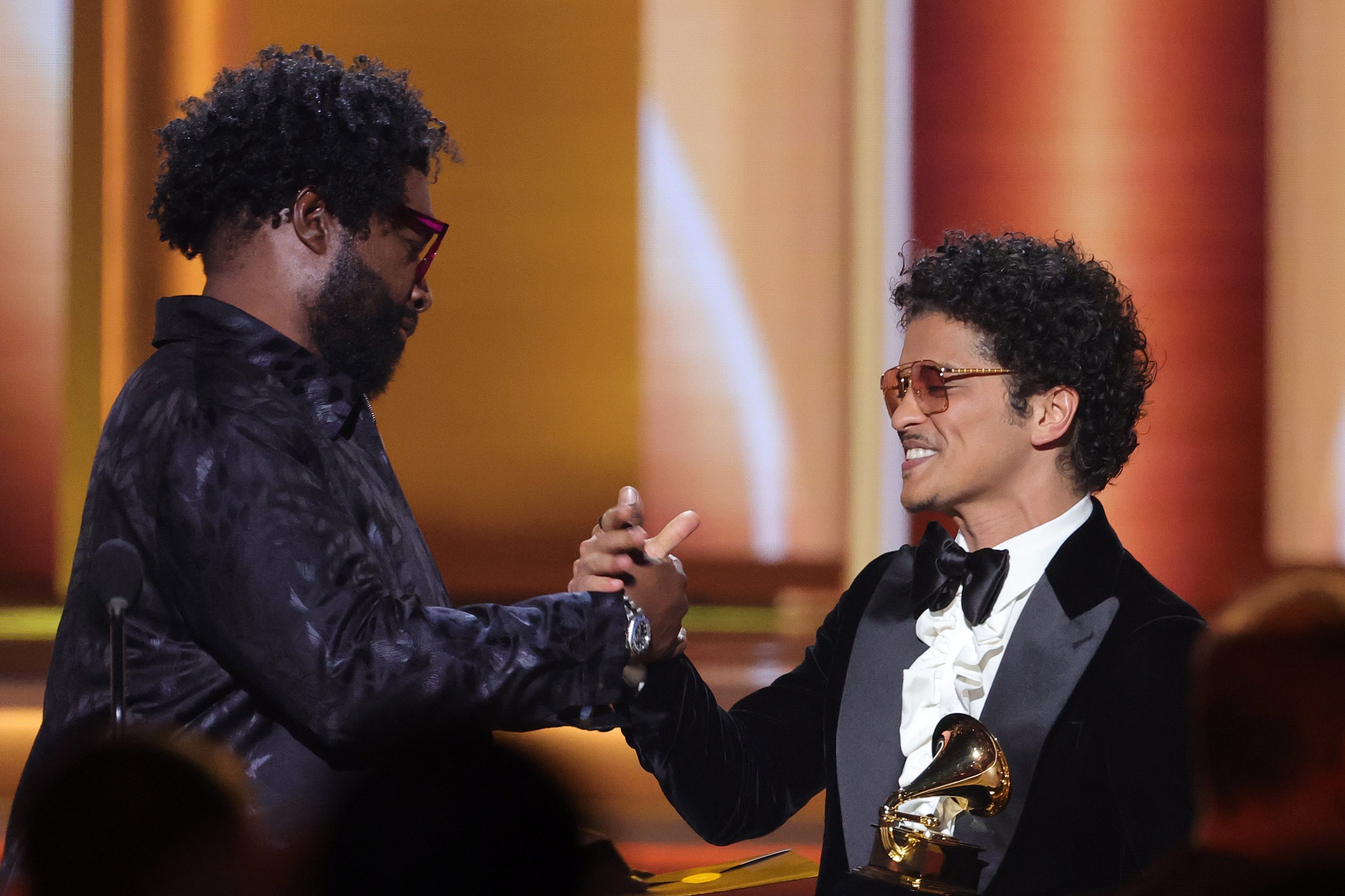 Ahmir 'Questlove' Thompson presents the Song Of The Year award for ‘Leave The Door Open’ to Bruno Mars of Silk Sonic onstage during the 64th Annual GRAMMY Awards