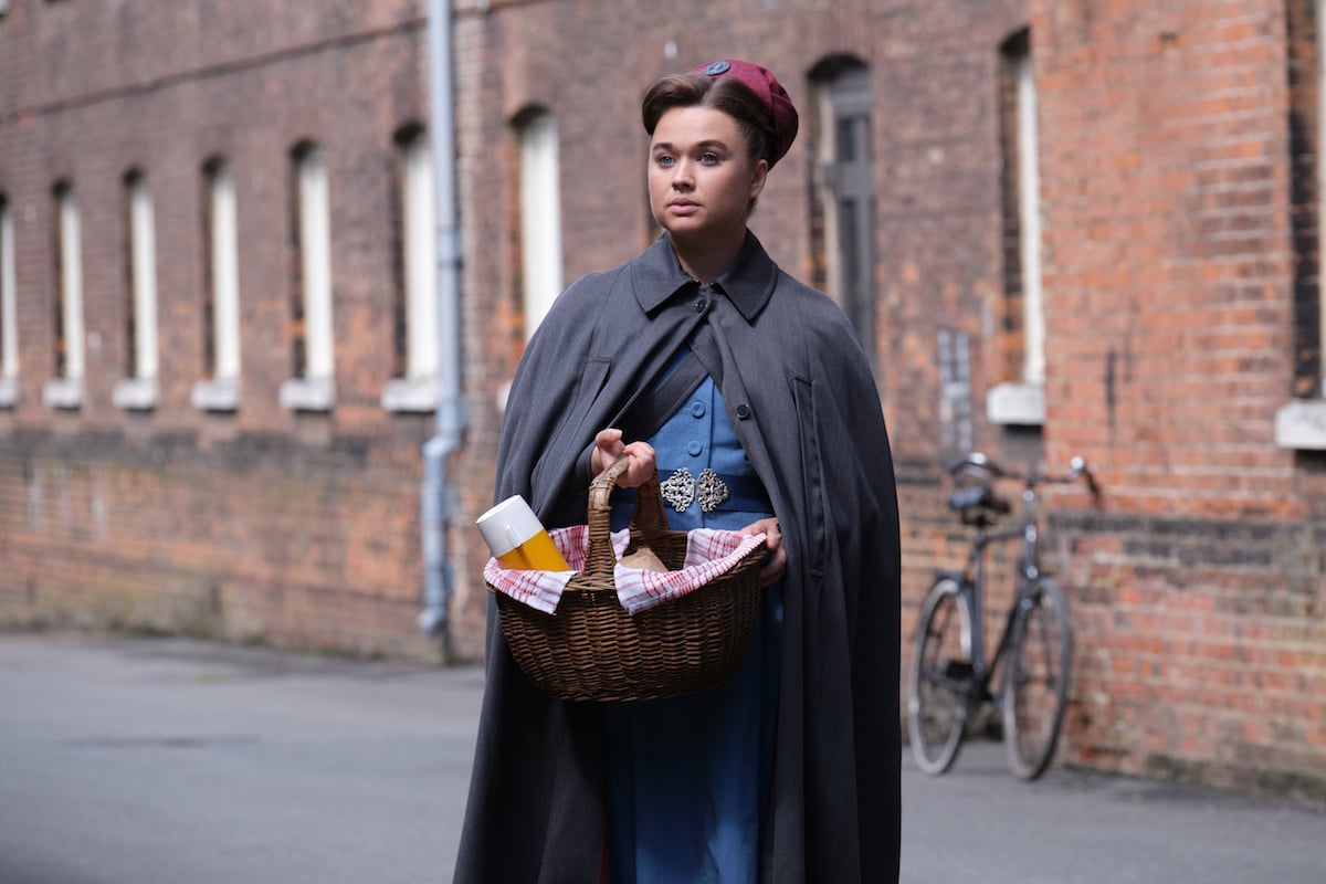 Nancy (Megan Cusack) in her nurse uniform and holding a thermos in 'Call the Midwife' Season 11