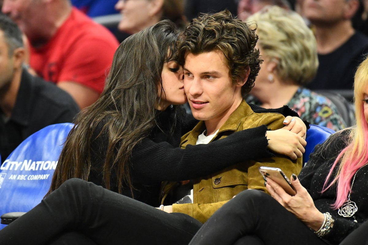 Camila Cabello kisses Shawn Mendes at an event.