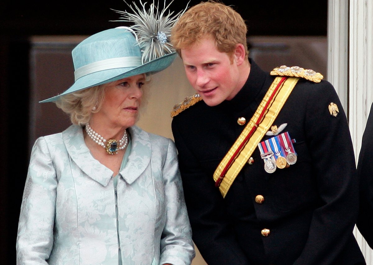 Camilla Parker Bowles and Prince Harry stand next to each other on the Buckingham Palace balcony