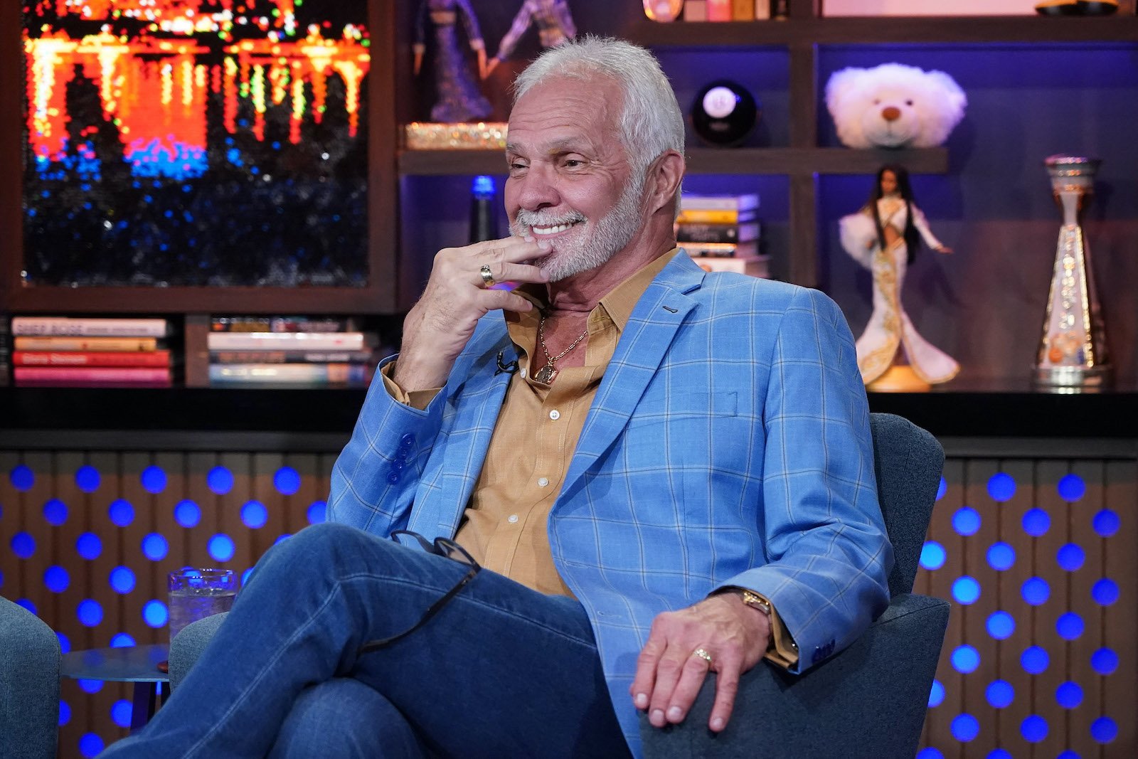 Captain Lee Rosbach from 'Below Deck' visits 'WWHL' and smiles in his seat.