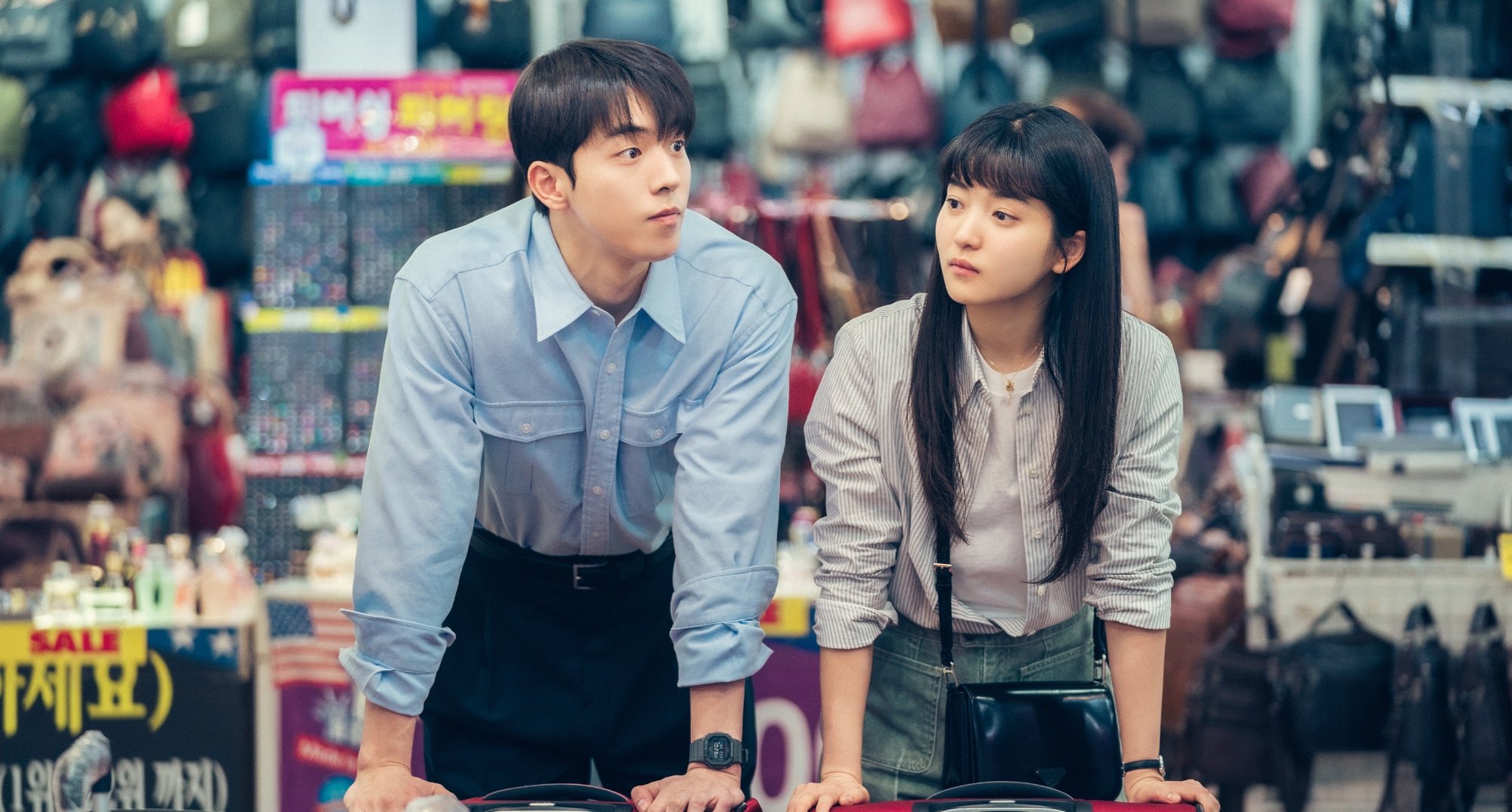 Characters Yi-jin and Hee-do in 'Twenty-Five Twenty-One' finale buying red suitcases.