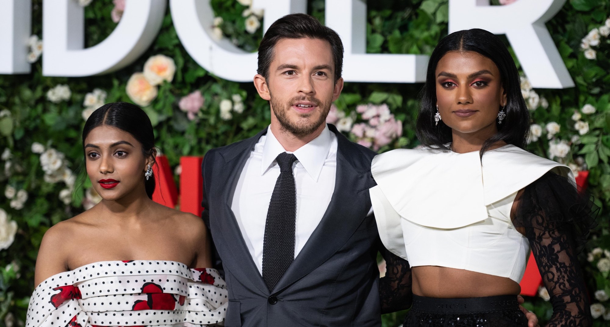 Charithra Chandran, Jonathan Bailey and Simone Ashley and cast for 'Bridgerton' Season 2 premiere standing next to each other.