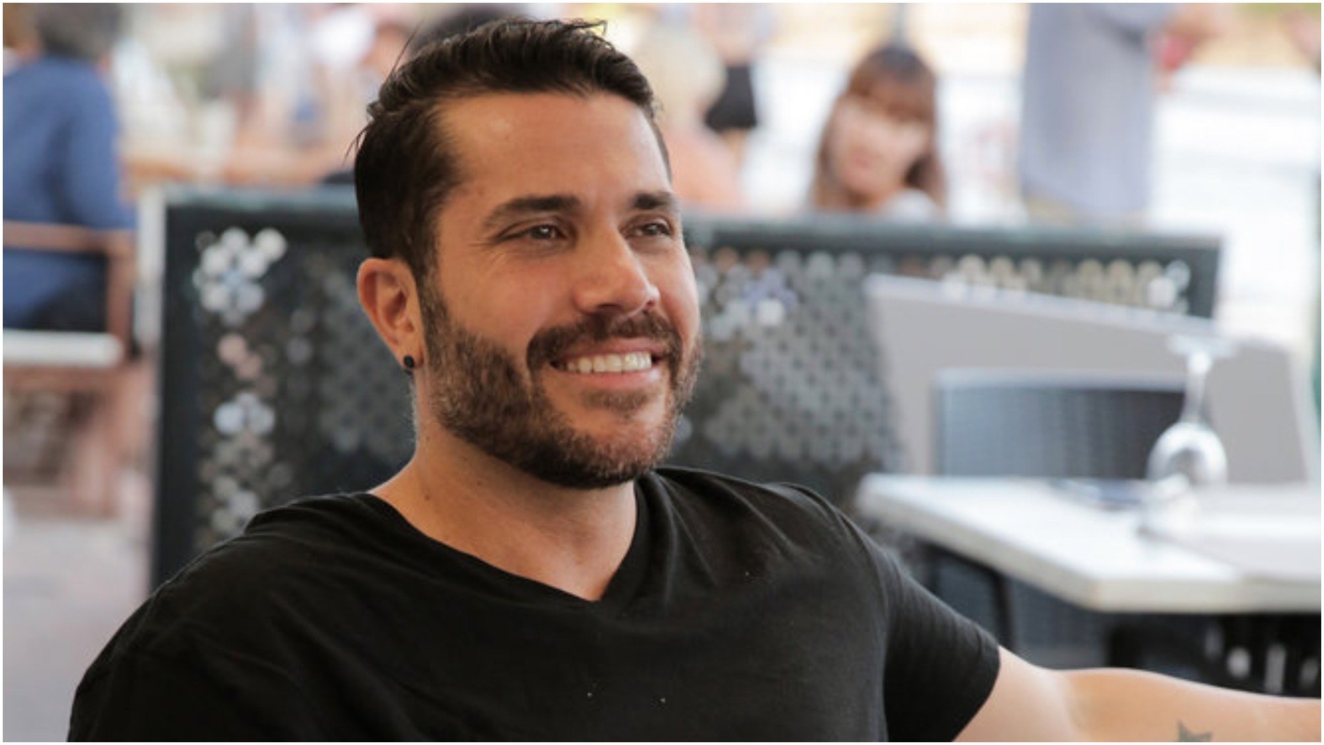 Chef Marcos Spaziani from 'Below Deck Sailing Yacht' smiles while having dinner with the crew 