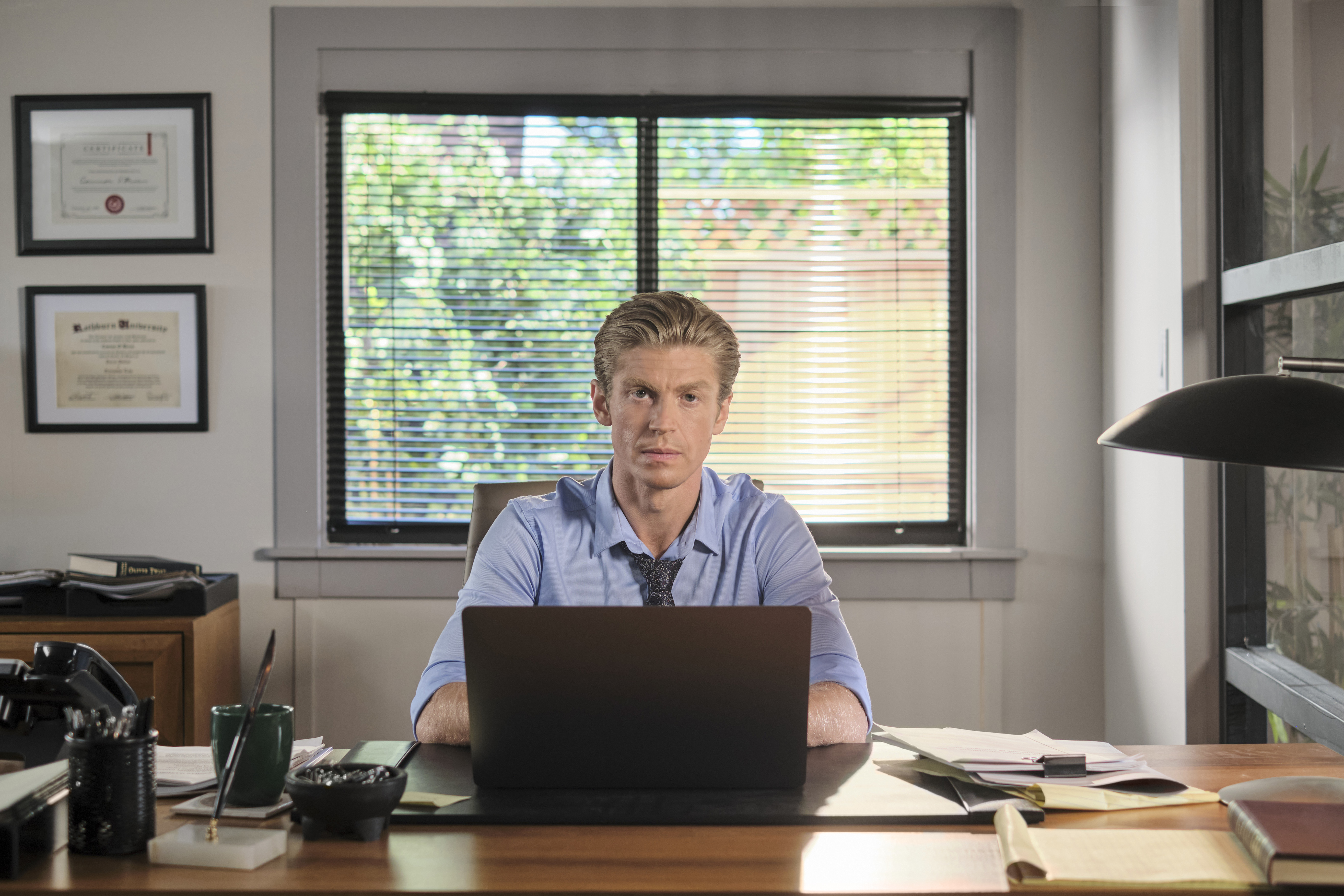 Connor (Andrew Francis) sitting behind a desk in 'Chesapeake Shores' Season 5