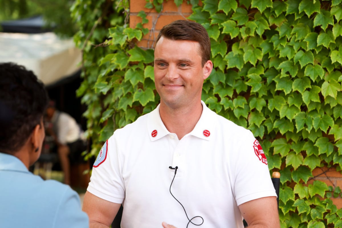 Jesse Spencer as Matthew Casey in Chicago Fire. Casey smiles wearing his captain's shirt.