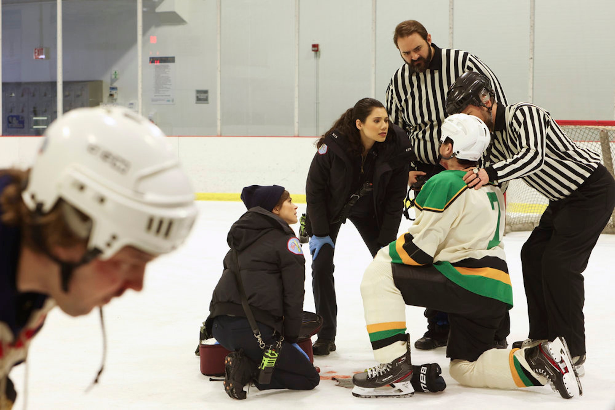 Emma Jacobs and Violet Mikami treating an ice hockey player in 'Chicago Fire' Season 17