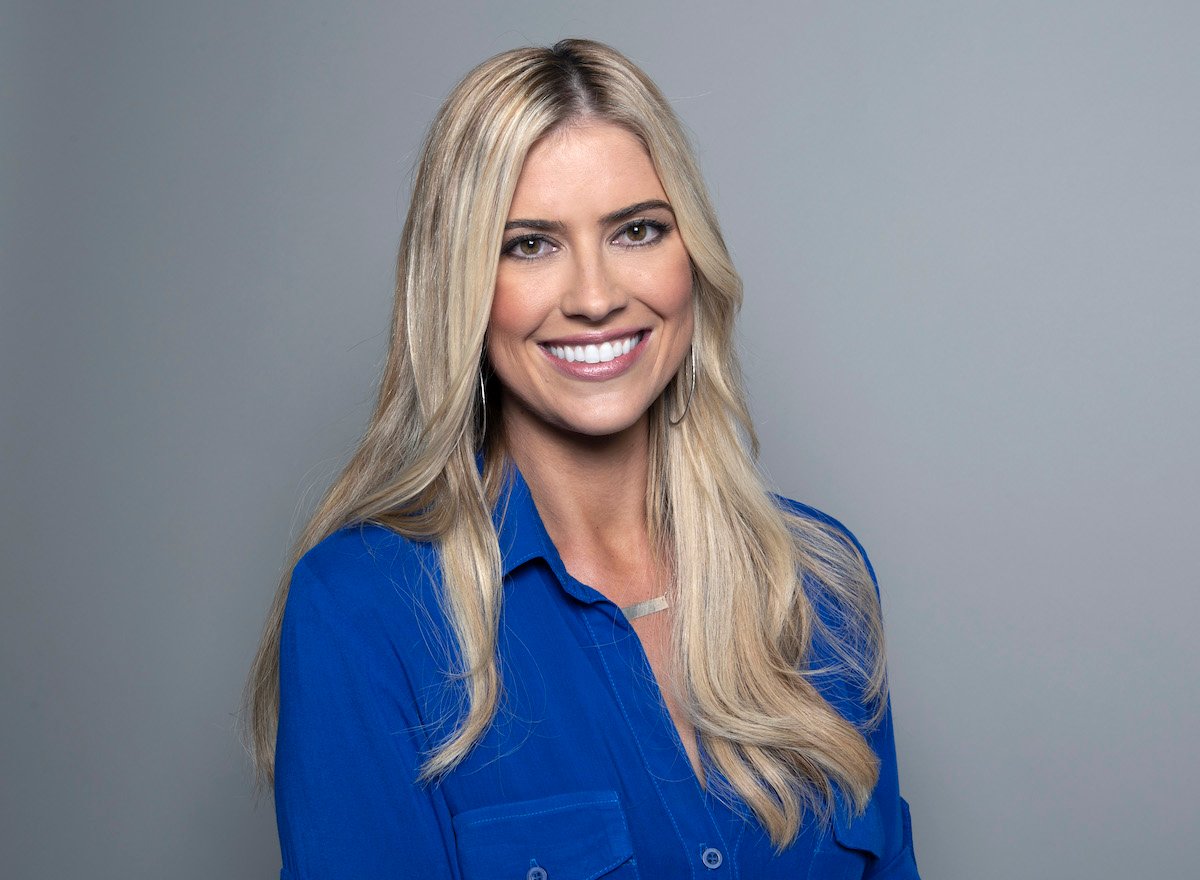 Christina Haack smiling and posing in a bright blue shirt.