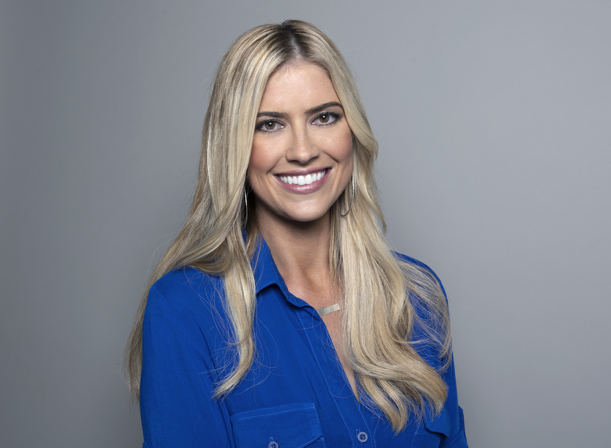 Christina Haack smiles for the camera in a bright blue shirt.