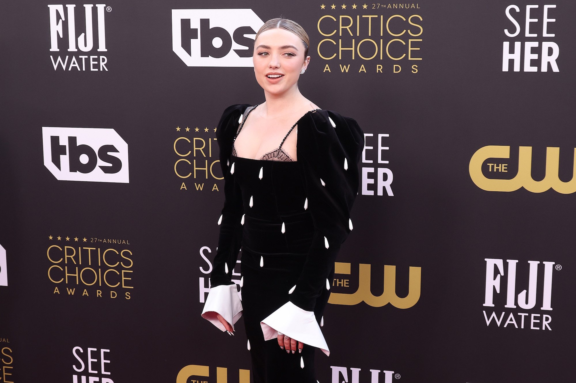 'Cobra Kai' star Peyton List looks to her left and smiles at the Critic's Choice Awards