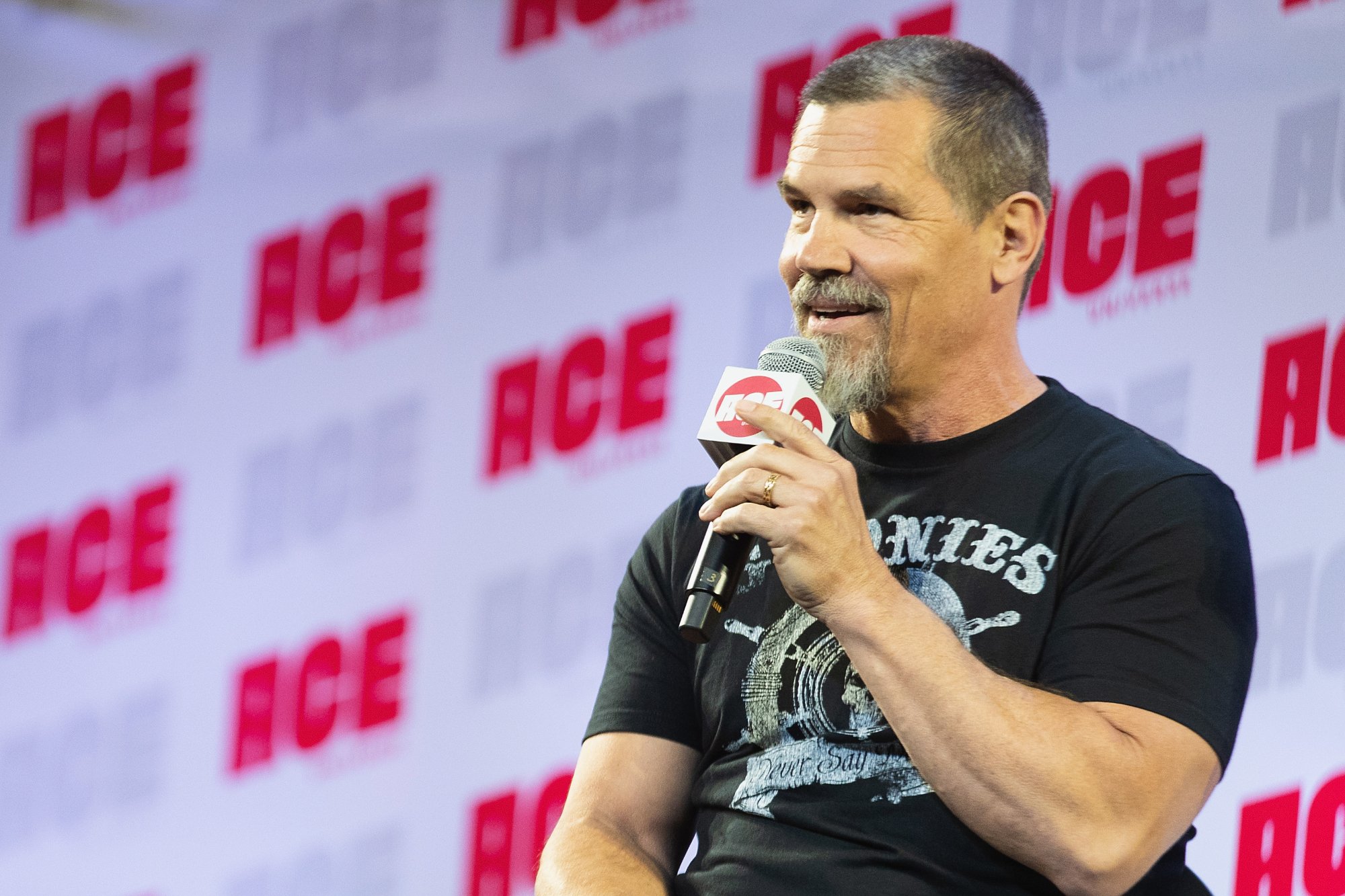 Coen Brothers' 'No Country for Old Men' star Josh Brolin talking into a microphone in front of ACE logo