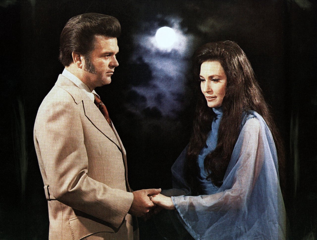 Loretta Lynn and Conway Twitty pose for a portrait