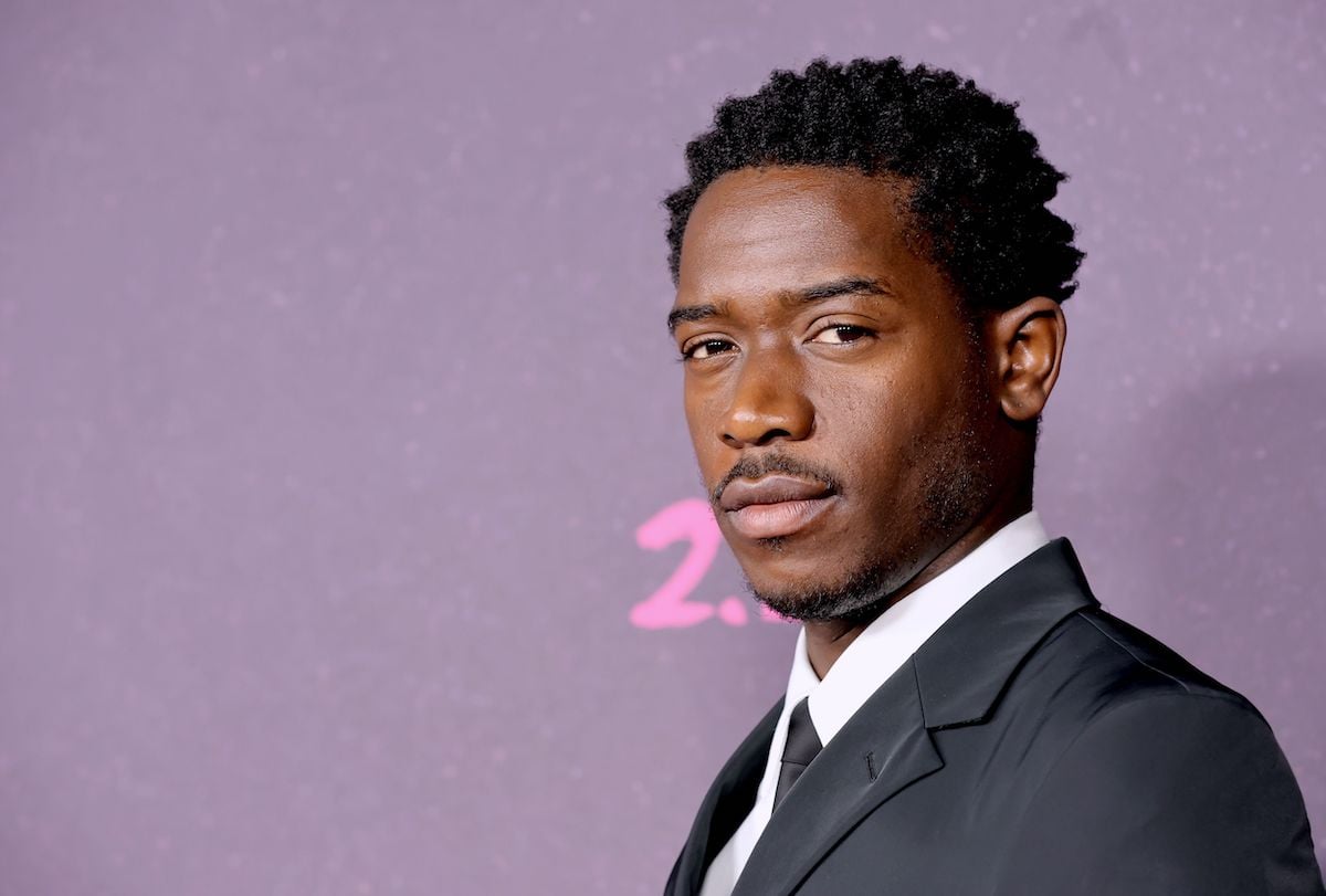 Damson Idris, who will appear in 'Snowfall' Season 6, poses on the red carpet wearing a black suit