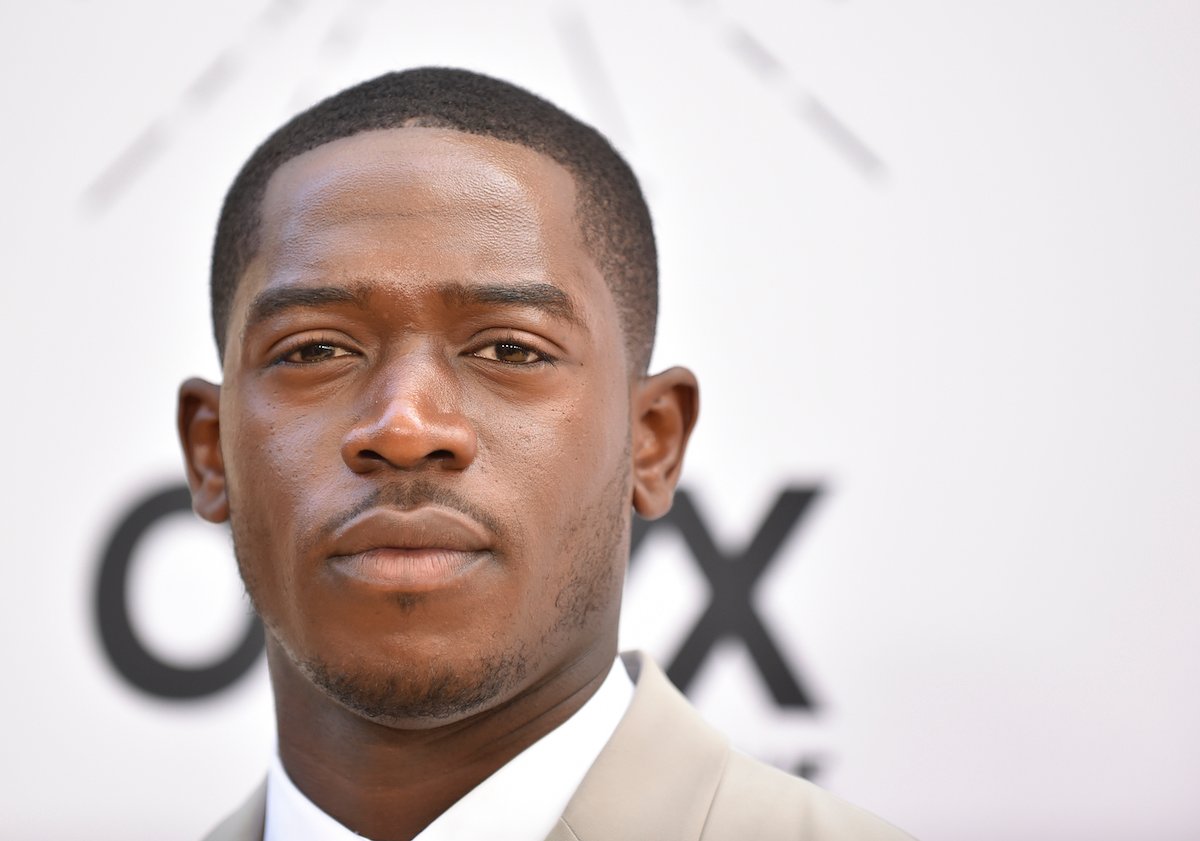 Damson Idris, who will reprise his role for 'Snowfall' Season 6 as Franklin Saint, poses for a photo wearing a beige suit and white undershirt