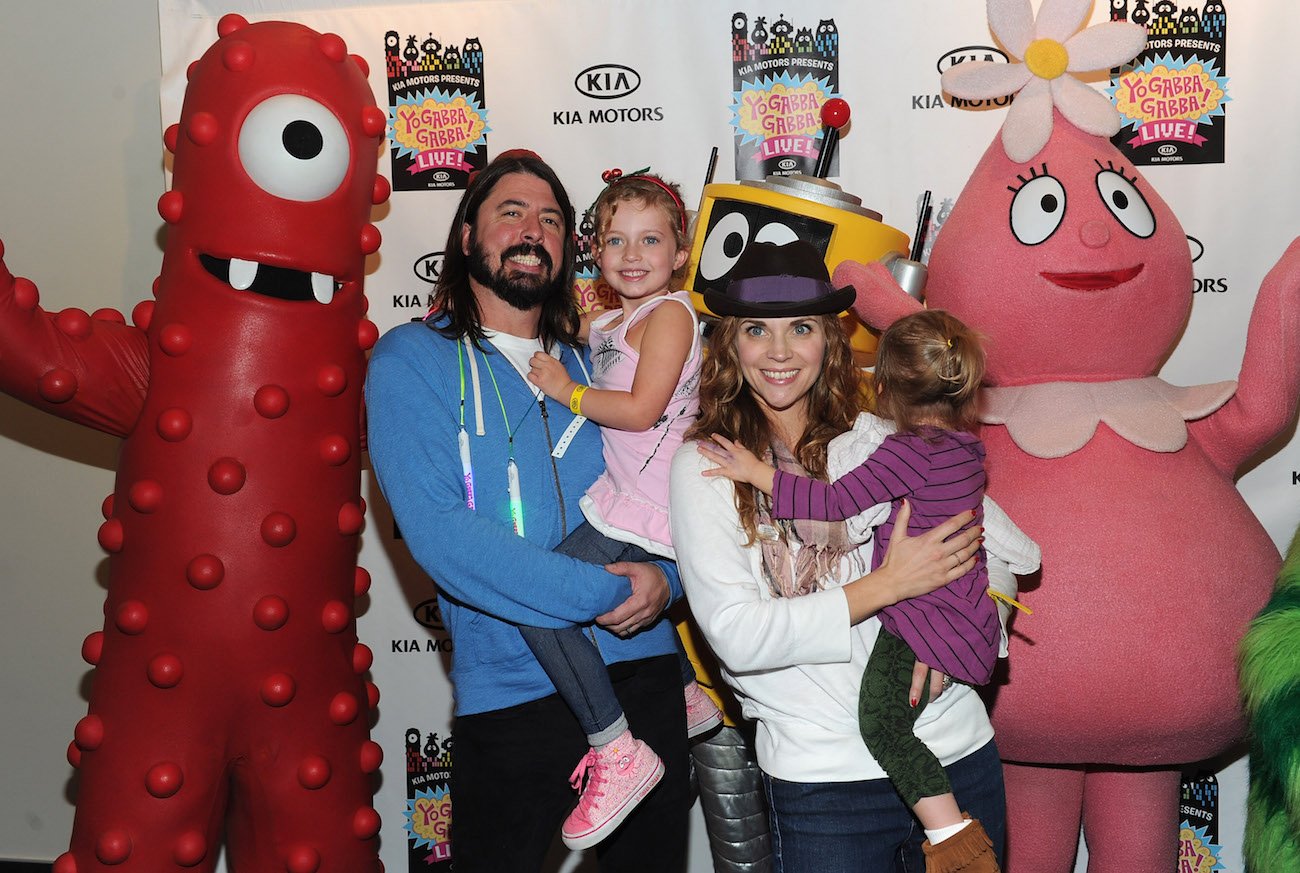 Dave Grohl holding his daughter and posing with his family at 'Yo Gabba Gabba' Live in 2010.