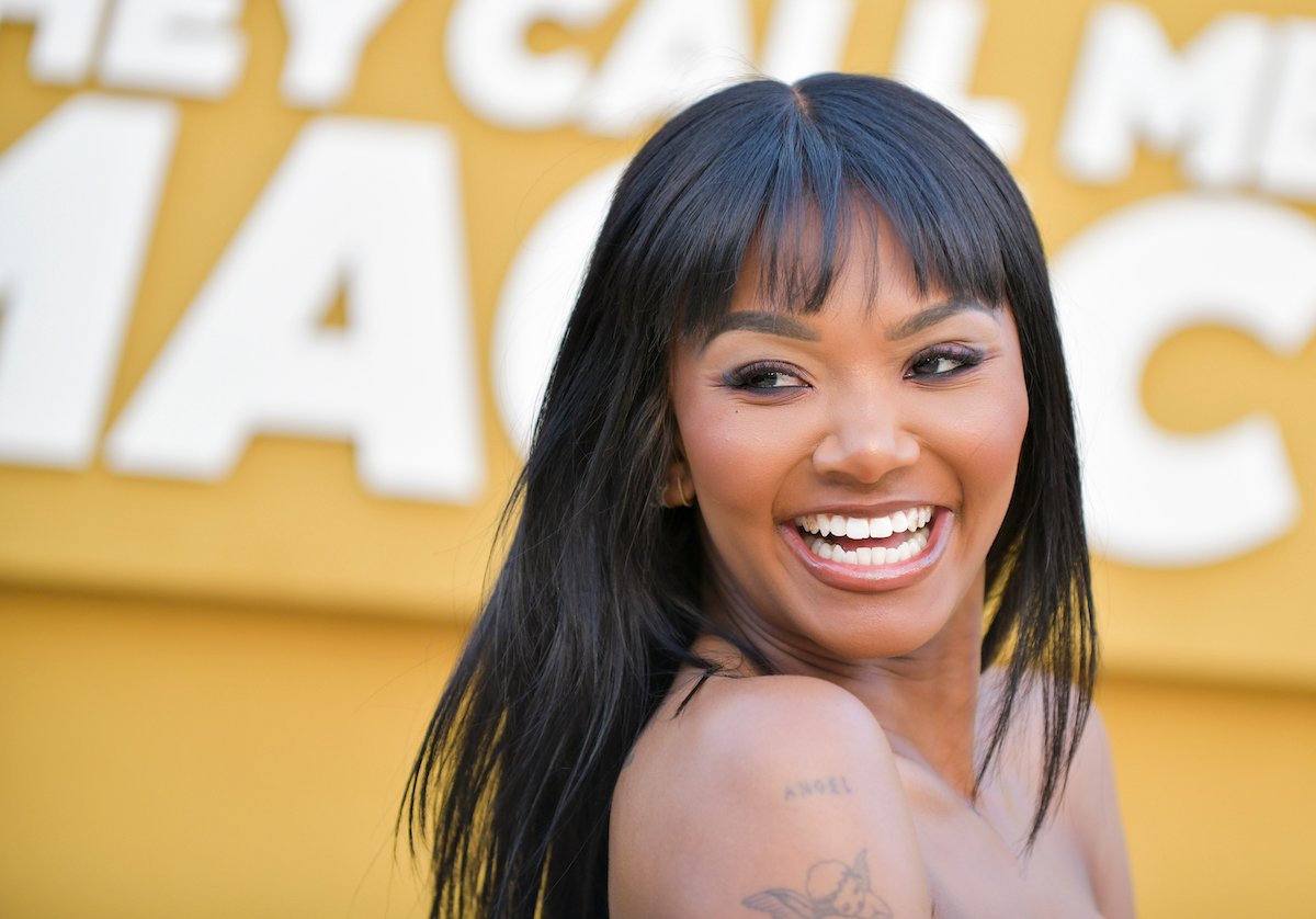 Elisa Johnson smiles while attending a TV premiere