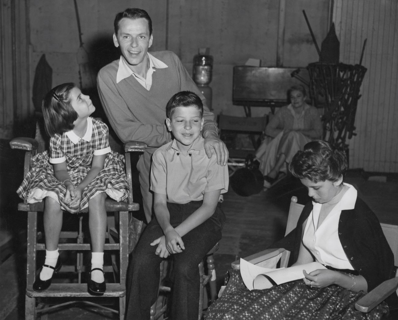 A black and white photo of Frank Sinatra with his children, Tina, Frank, and Nancy.