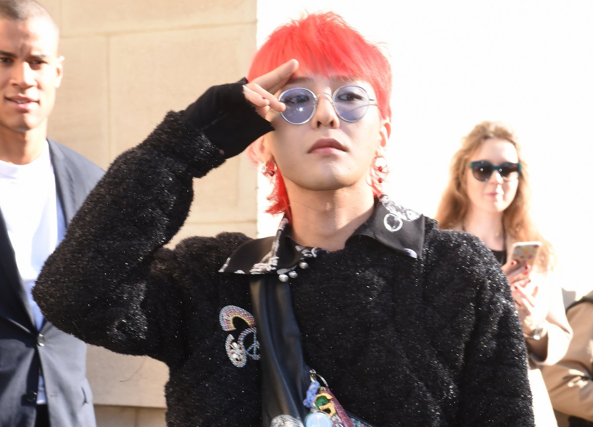 G-Dragon poses on the streets of Paris while attending a Chanel fashion show