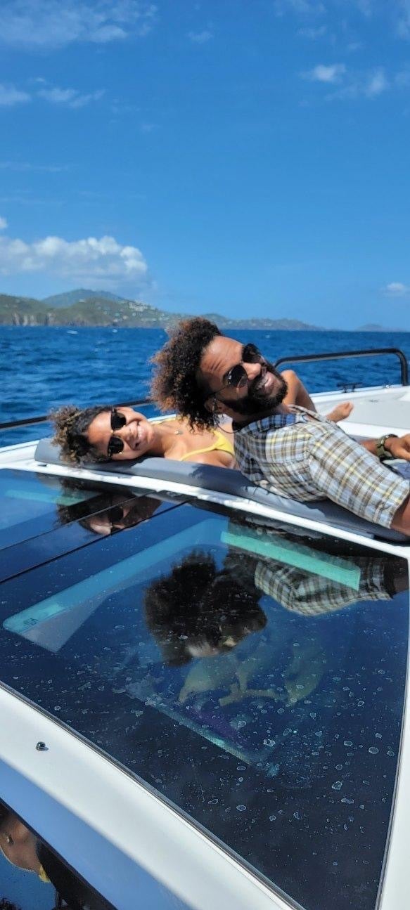 Gabriela Barragan and Wes O'Dell smile from a sailing yacht 