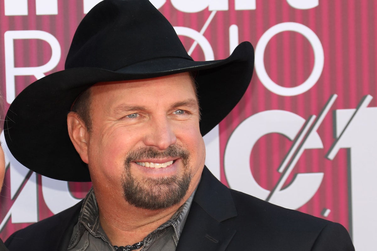 Garth Brooks smiles for the camera in a cowboy hat.