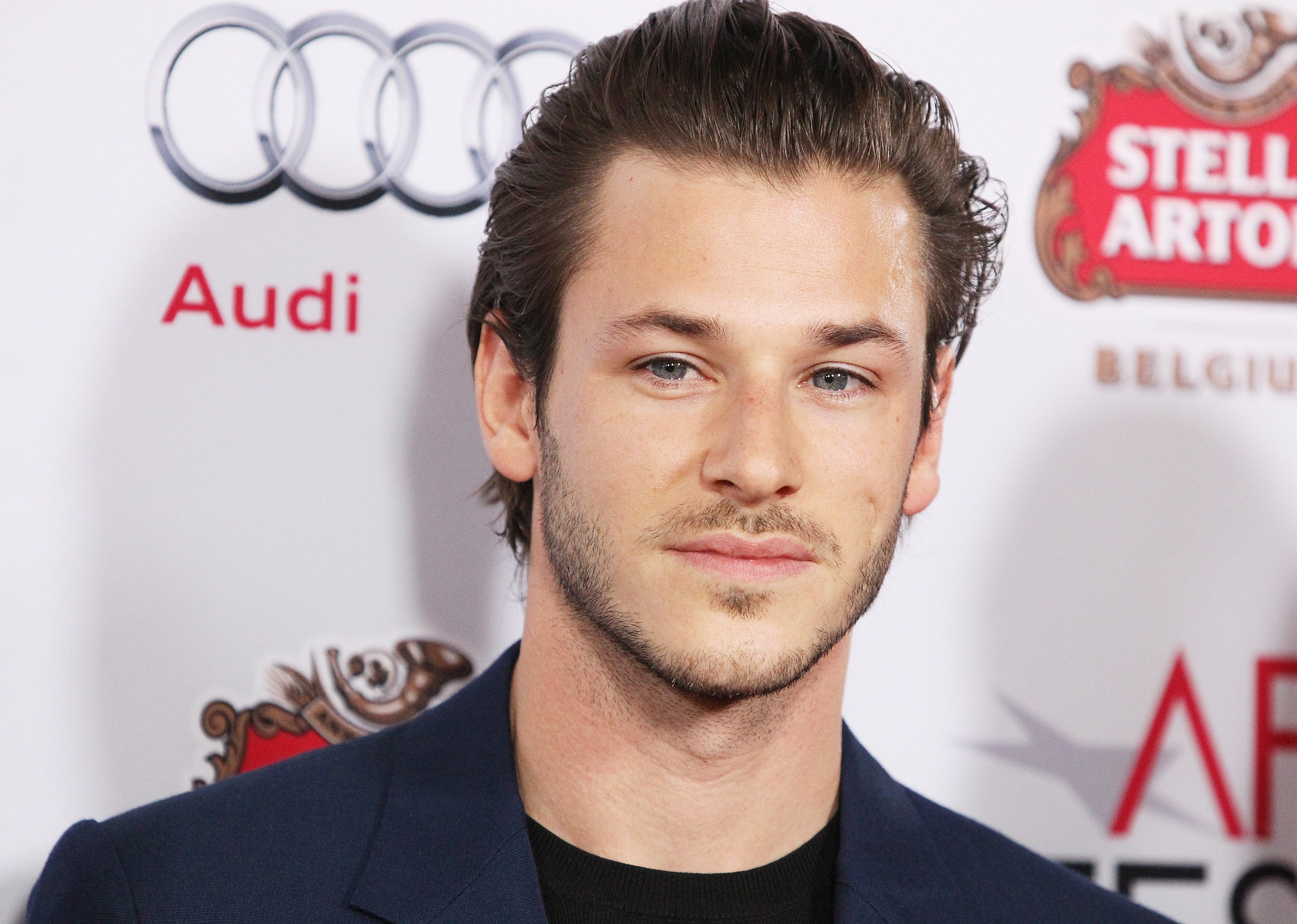 'Moon Knight' star Gaspard Ulliel wears a dark blue suit over a black shirt.