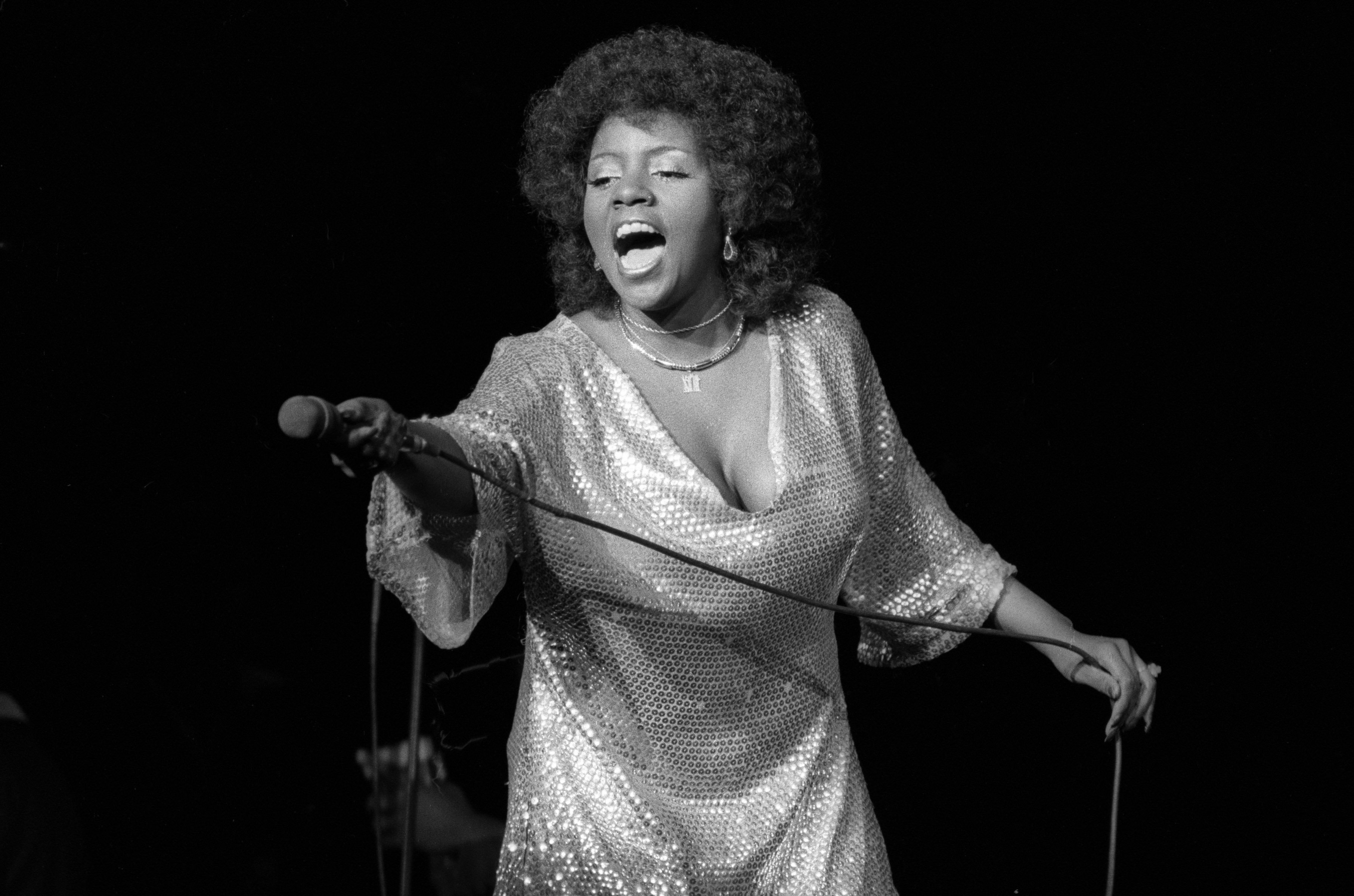 Gloria Gaynor holding a microphone