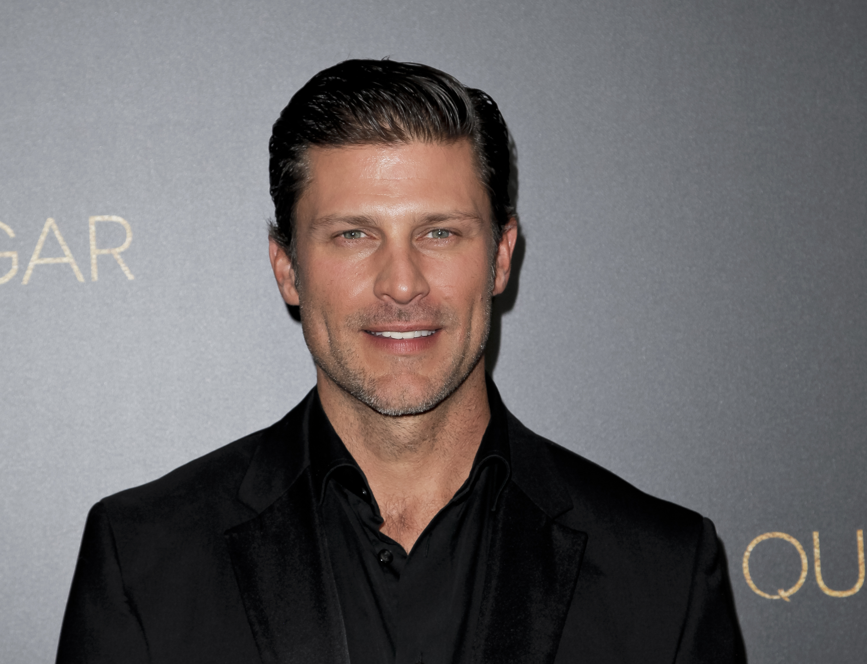 'Days of Our Lives' actor Greg Vaughan wearing a black suit during a red carpet appearance.