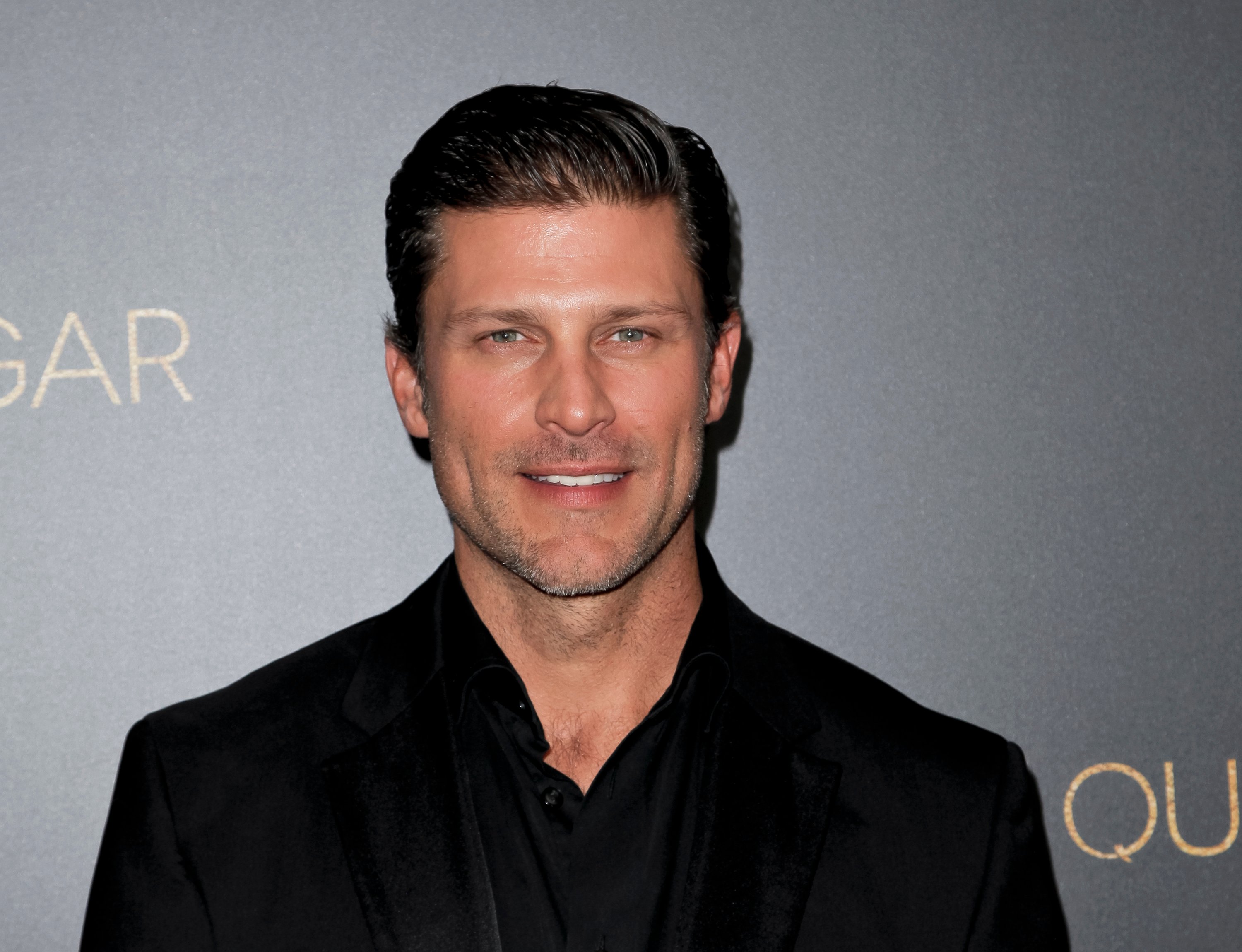 'Days of Our Lives' actor Greg Vaughan wearing a black suit during a red carpet appearance.