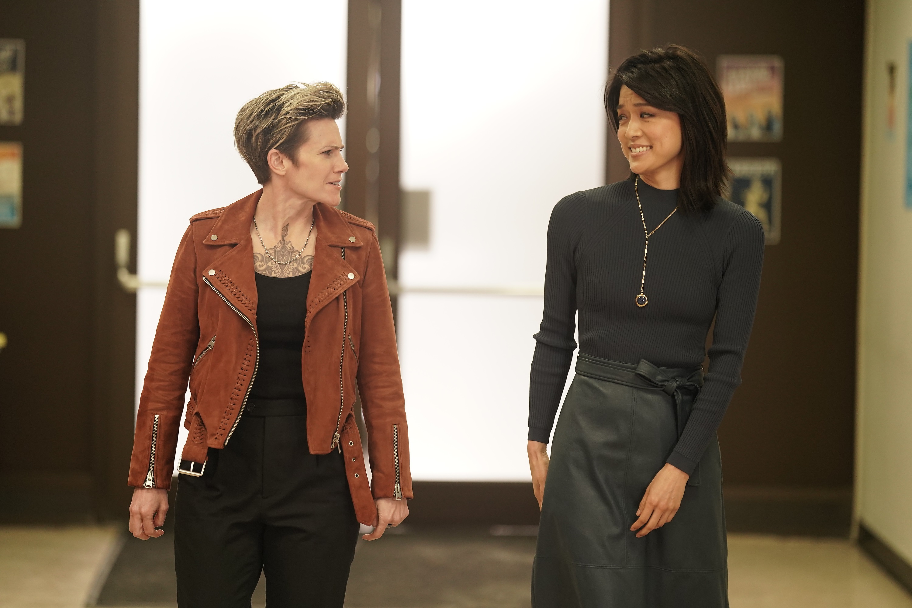 'A Million Little Things' Cameron Esposito and Grace Park look at each other as Greta and Katherine