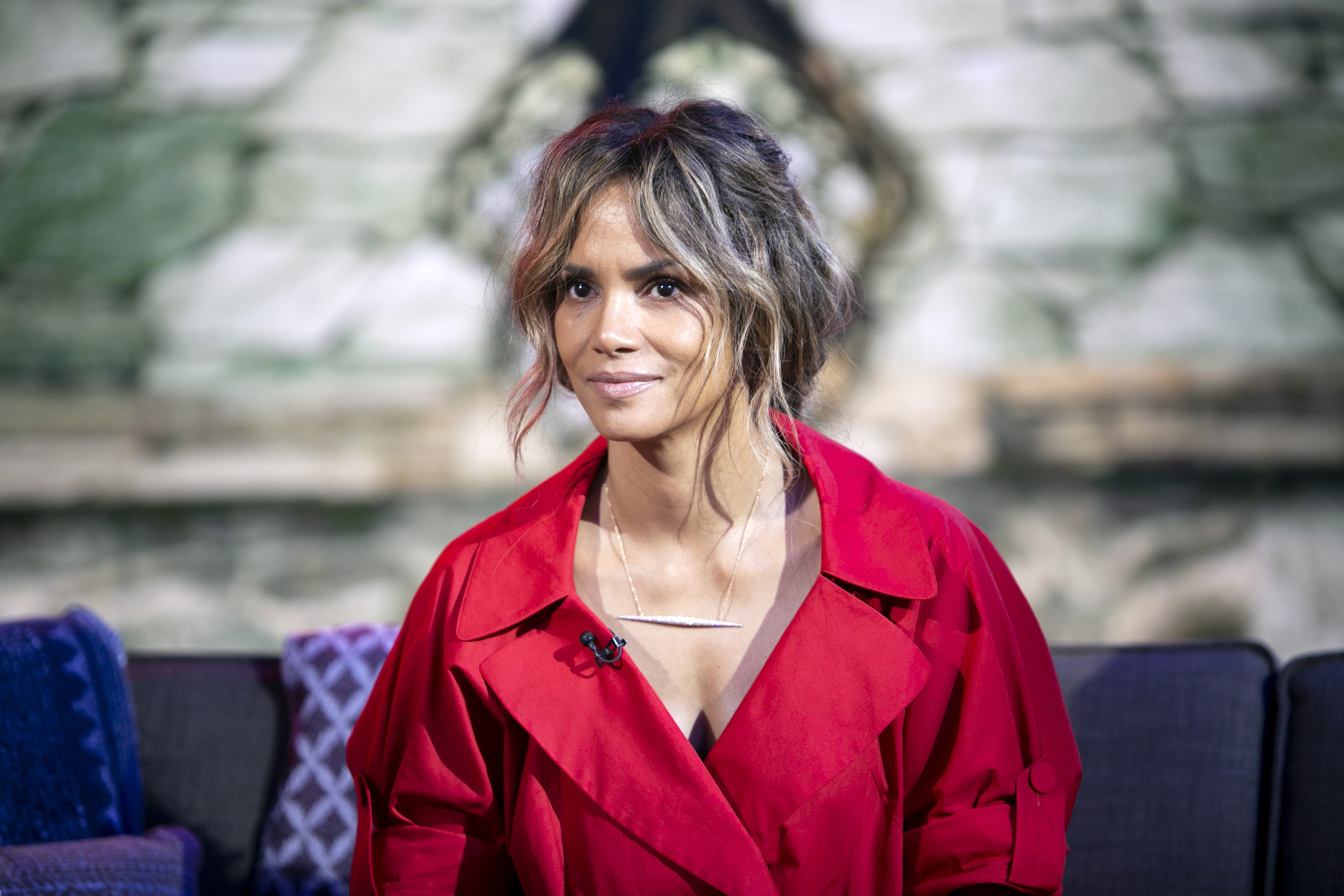Halle Berry on TODAY wearing a red outfit accessorized with a necklace and most of hair swept back