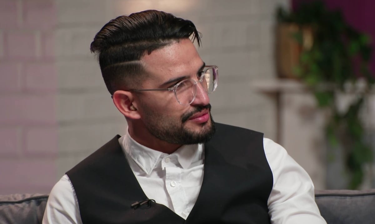 Hamza Moknii wearing glasses and suit on set of '90 Day Fiancé: Before the 90 Days' Season 5 tell-all in New York City.