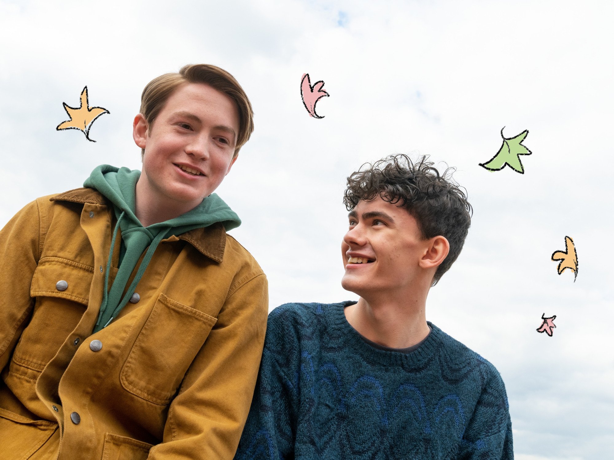Key art for Netflix's adaptation of Alice Oseman's 'Hearstopper' graphic novels. It features Kit Connor and Joe Locke. They're both smiling, and there are clouds behind them.