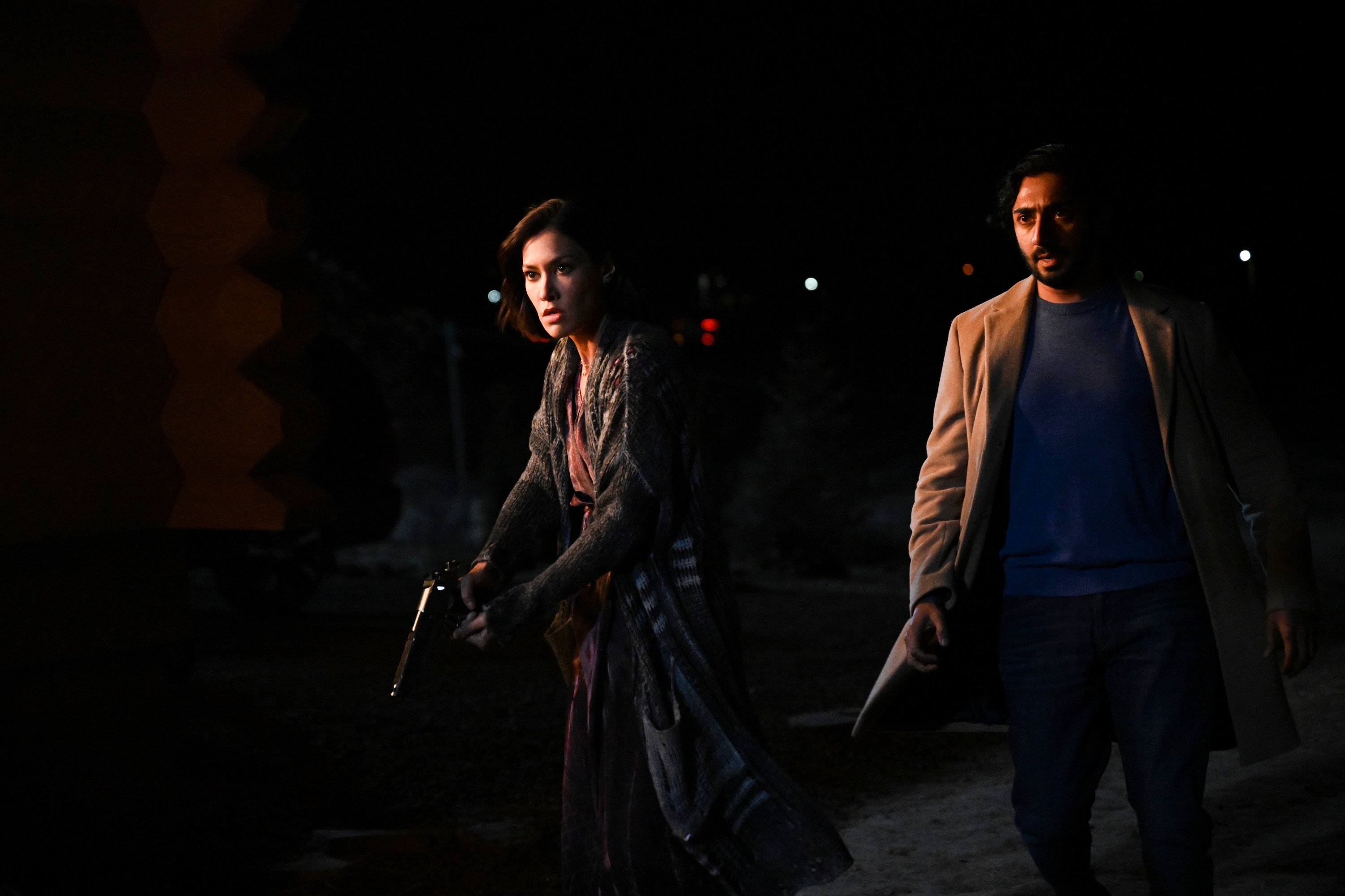 'Big Sky' Janina Gavankar and Vinny Chhibber with guns in hand in the dark as Ren and Jag