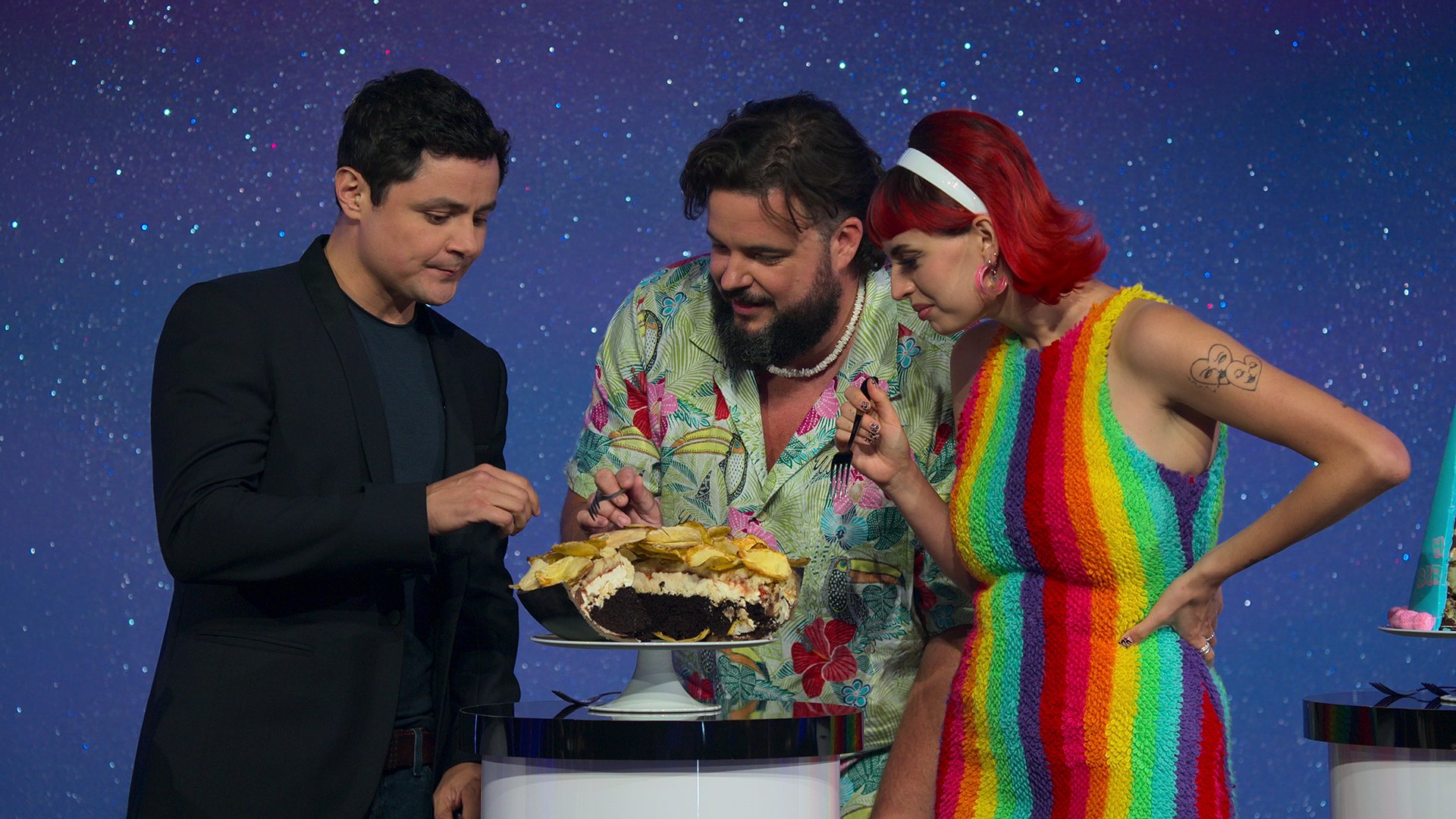 Celebrity guest judges from Is It Cake? Episode 5 taste the bowl of chips cake.