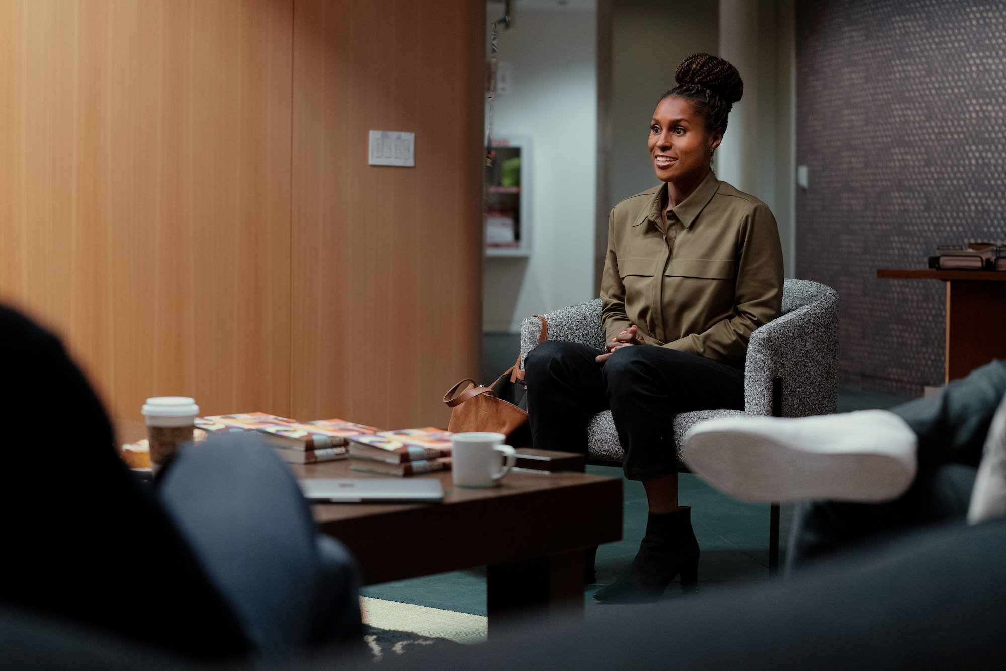 Issa Rae sits in a meeting on 'Roar'