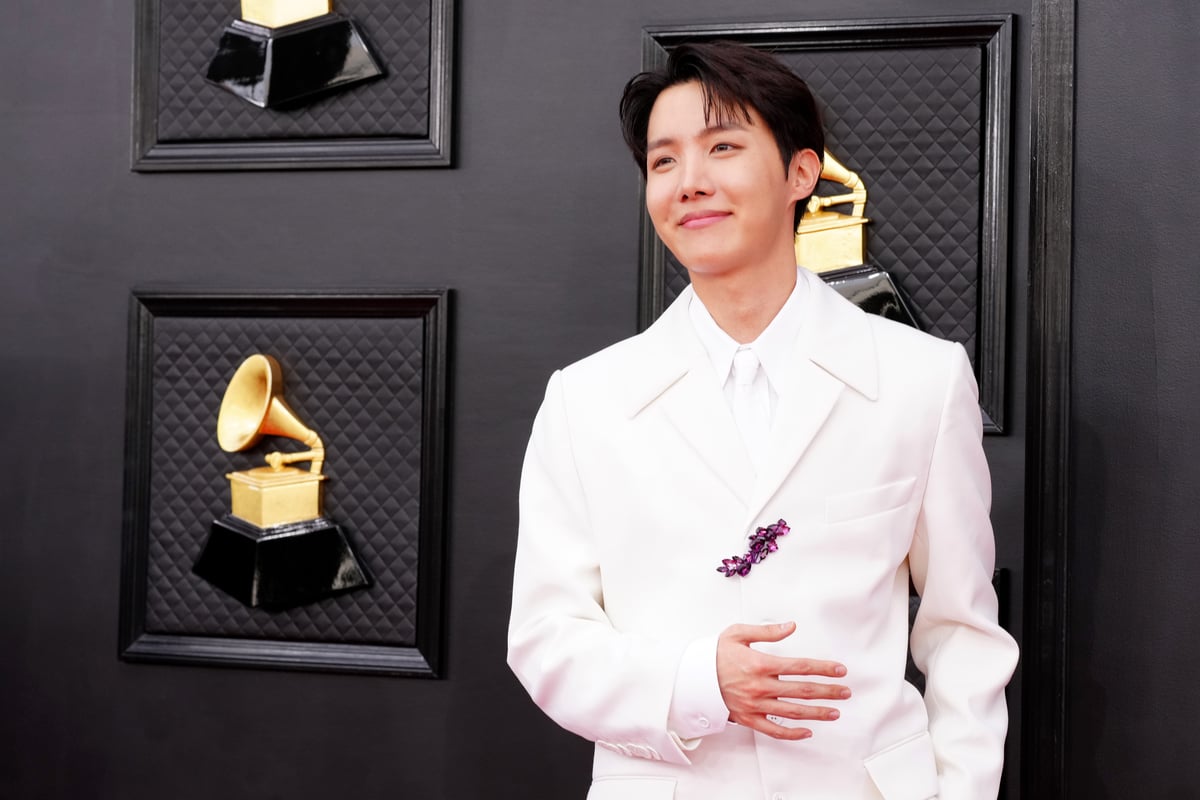 Dressed in a white suit, J-Hope from BTS poses on the red carpet at the Grammy Awards in Las Vegas, NV.