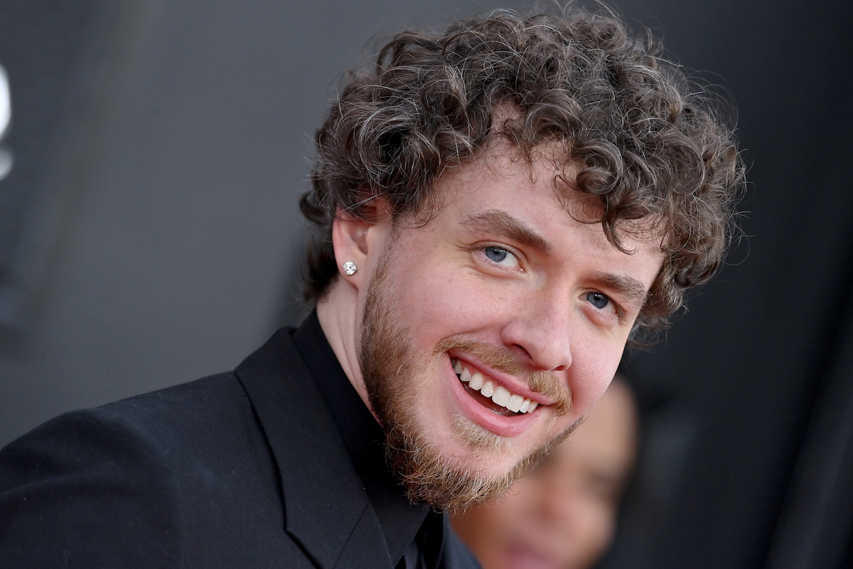 Jack Harlow smiles wearing a black suit at the 2022 Grammy Awards