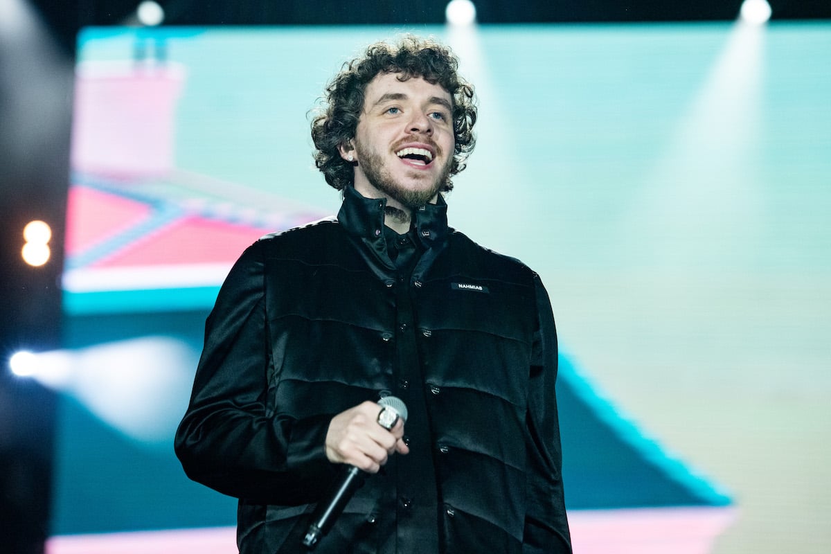 Rapper Jack Harlow holds a mic while wearing a black outfit during a performance at Rolling Loud