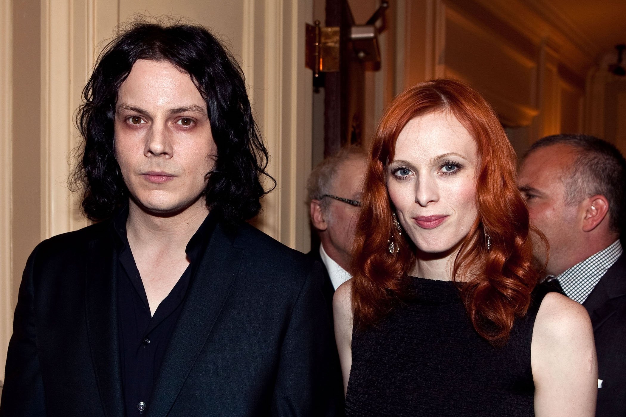 Jack White and wife Karen Elson standing next to each other. They're both wearing black.