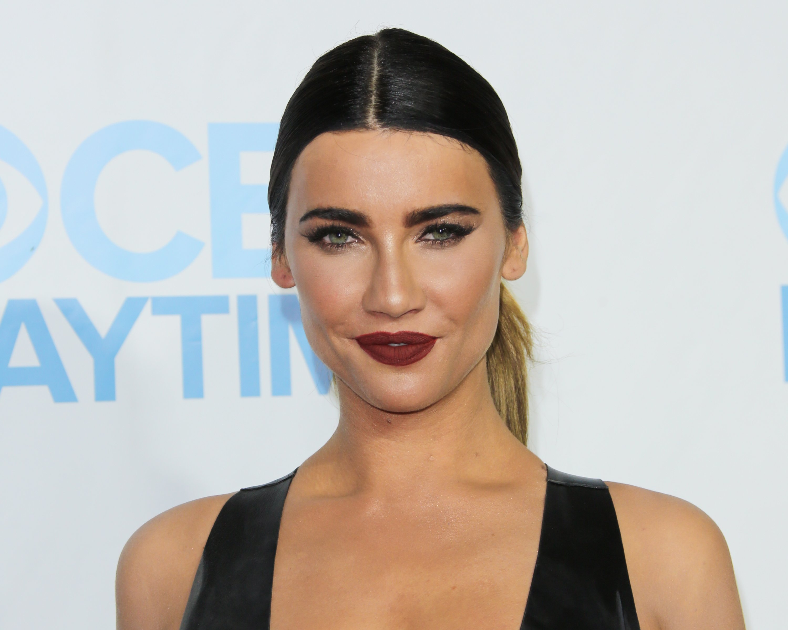 'The Bold and the Beautiful' actor Jacqueline MacInnes Wood in a black dress, dark lipstick, and a slick ponytail.