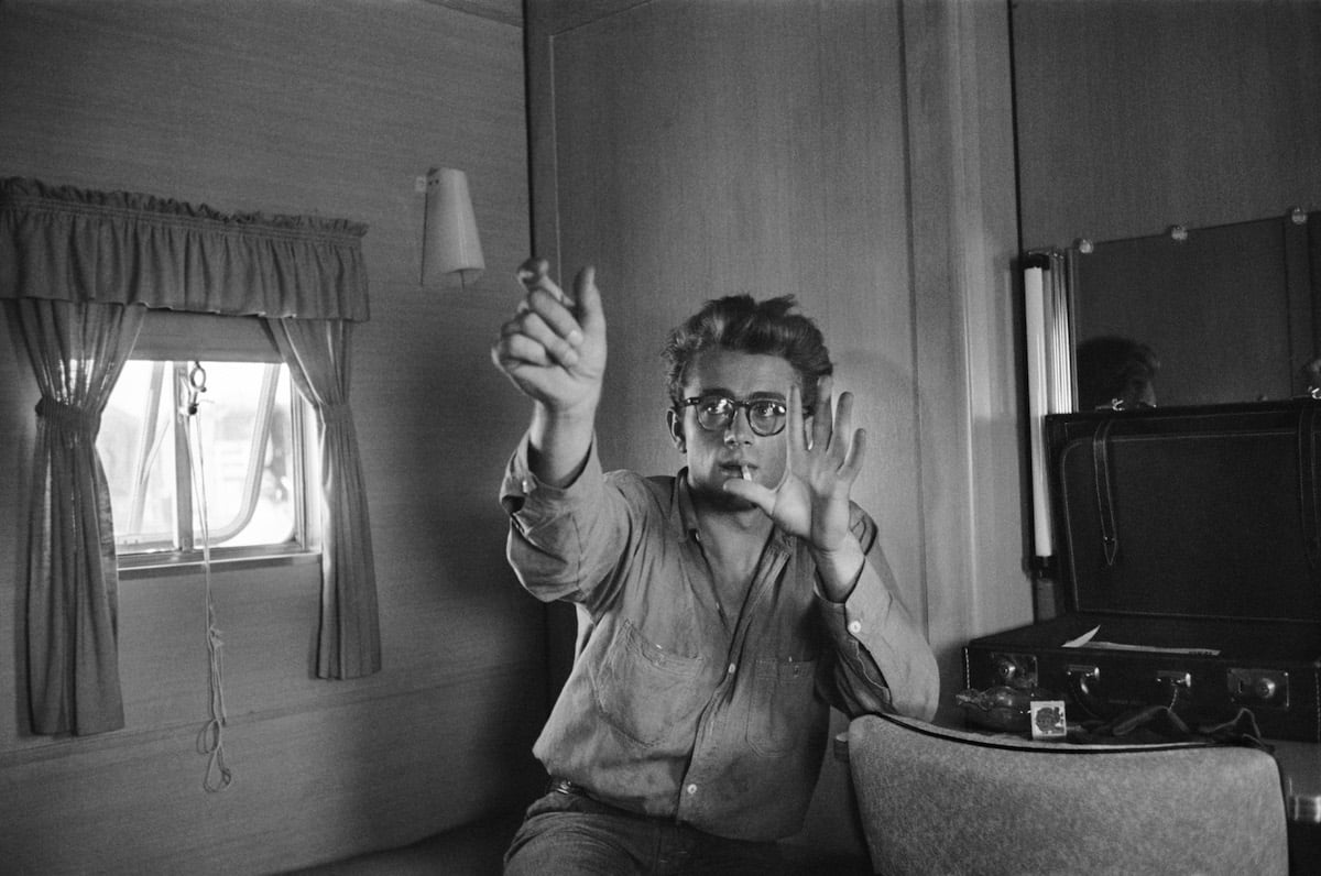 James Dean gesturing, smoking, in black and white