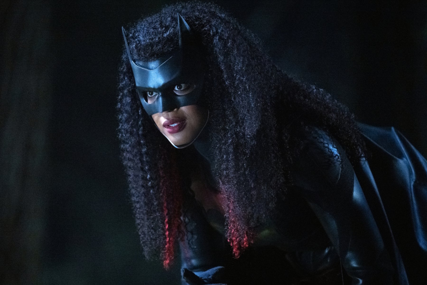 Javicia Leslie as Batwoman in The CW's 'Batwoman,' which received a cancellation. Her hair is down, and she's wearing the black mask and Batsuit.