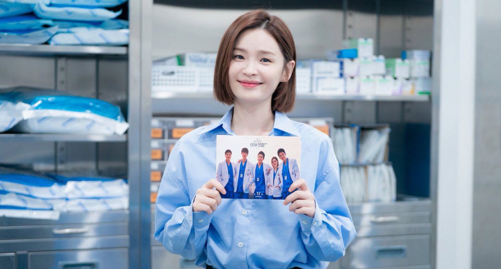 Jeon Mi-do from 'Hospital Playlist' holding cast photo in relation to Season 3.